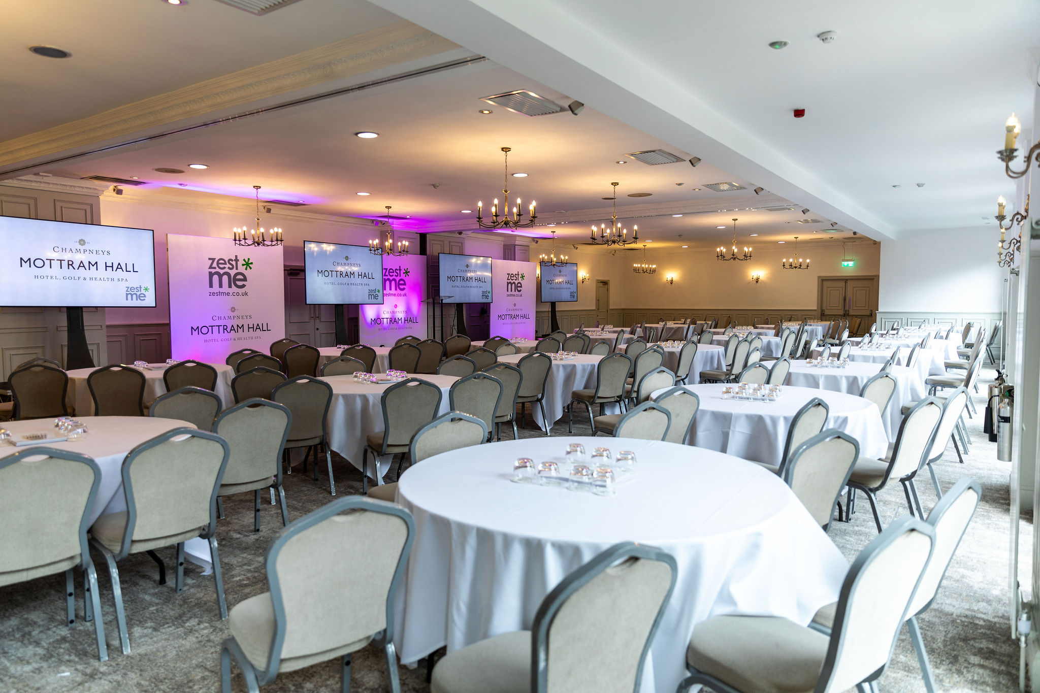 St Andrews Suite at Mottram Hall, ideal for corporate meetings with round tables and screens.