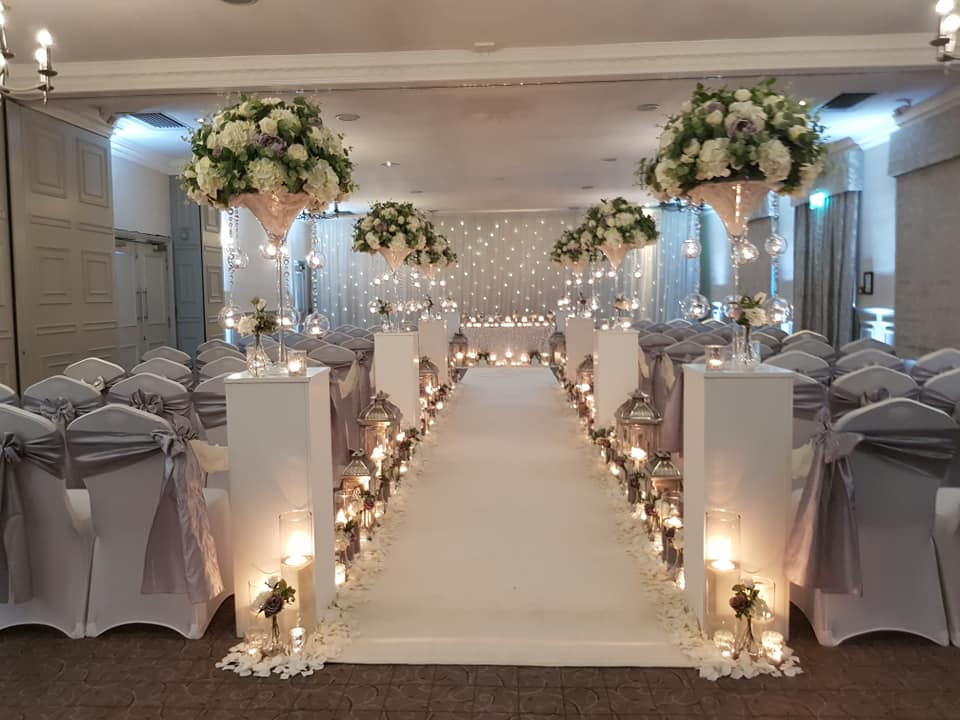 St Andrews Suite wedding setup with floral arrangements and elegant aisle decor.
