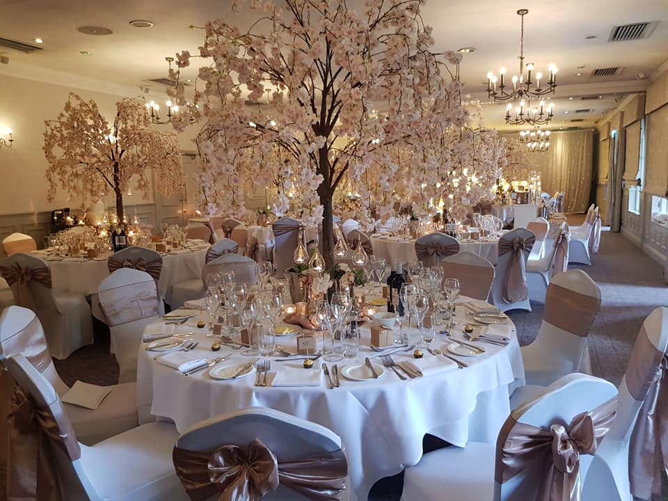 St Andrews Suite at Mottram Hall, elegant banquet hall with faux tree centerpiece for weddings.