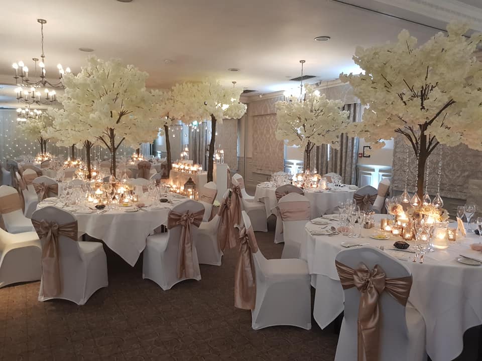 St Andrews Suite at Mottram Hall, elegant wedding venue with white floral centerpieces.