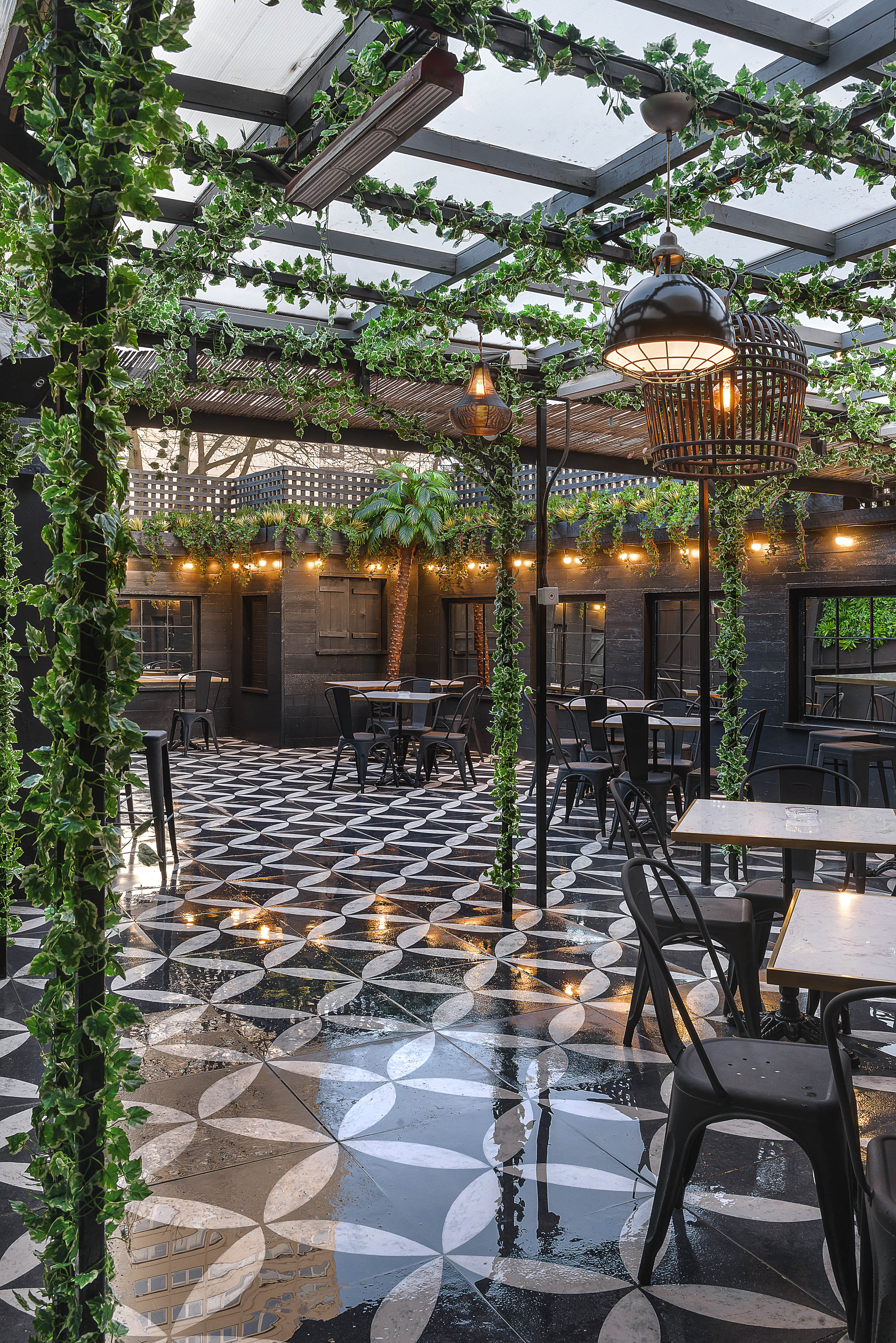 Stylish outdoor venue with black and white flooring, perfect for events and gatherings.
