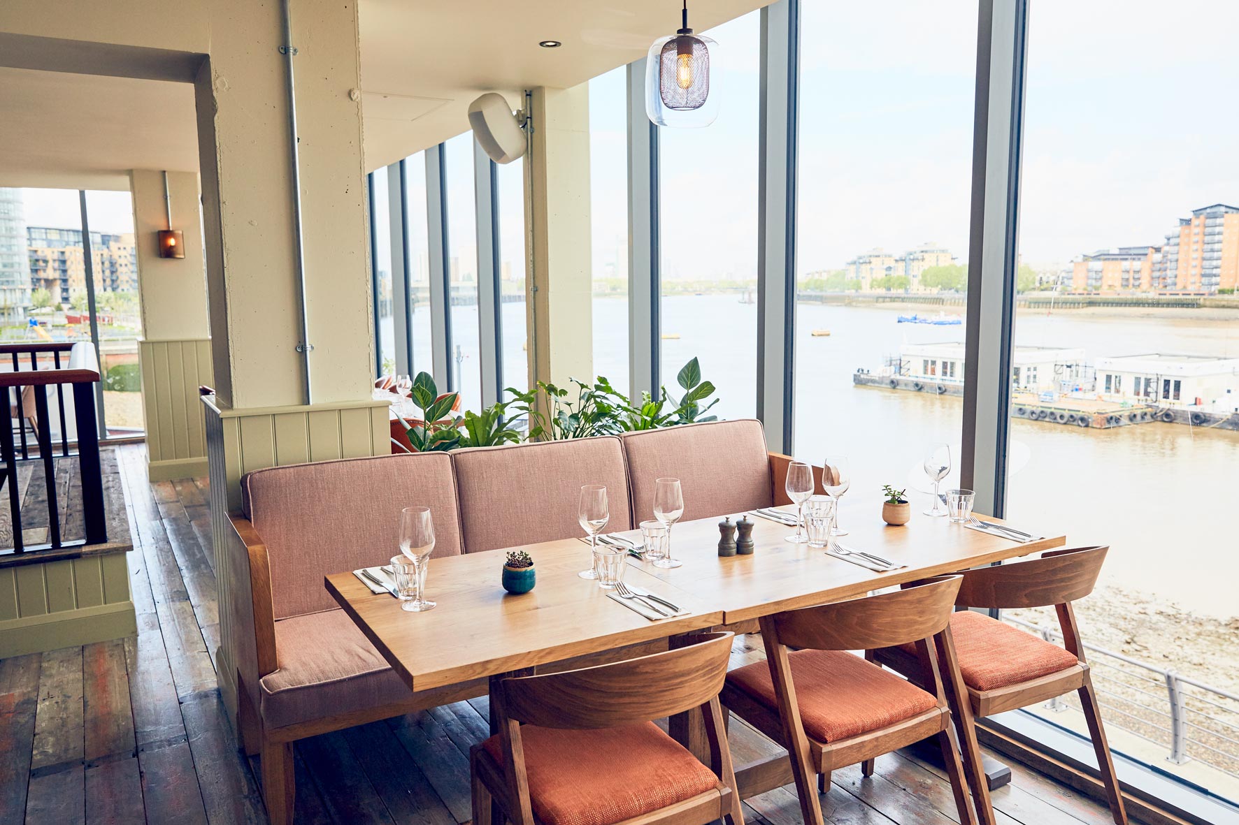 Stylish dining area with river view, perfect for intimate meetings and events.
