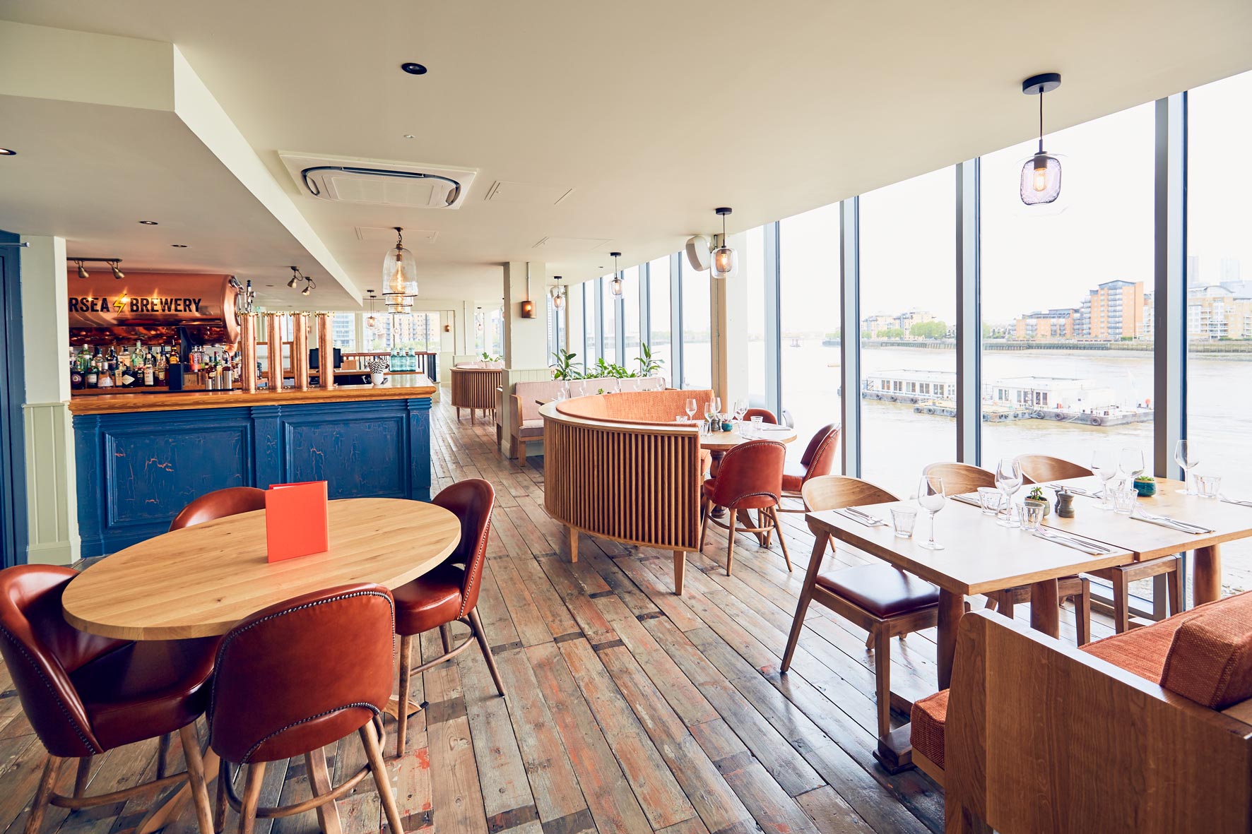 Modern event space with large windows, ideal for meetings and social gatherings.