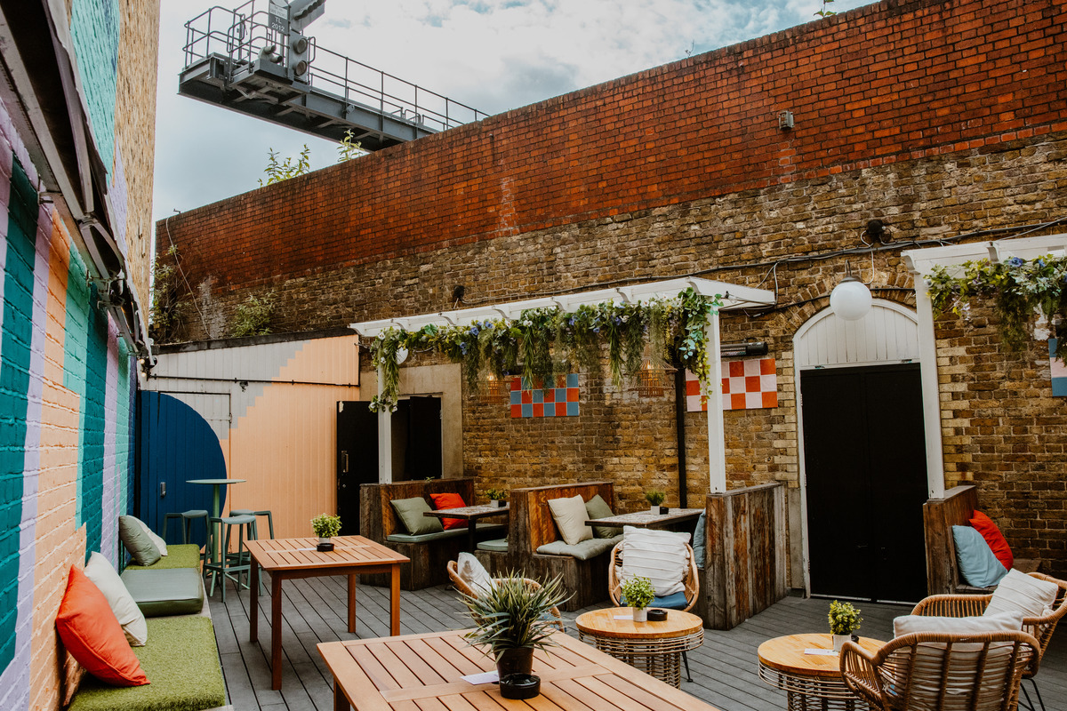 Charming outdoor event space with rustic decor, perfect for summer parties and networking.