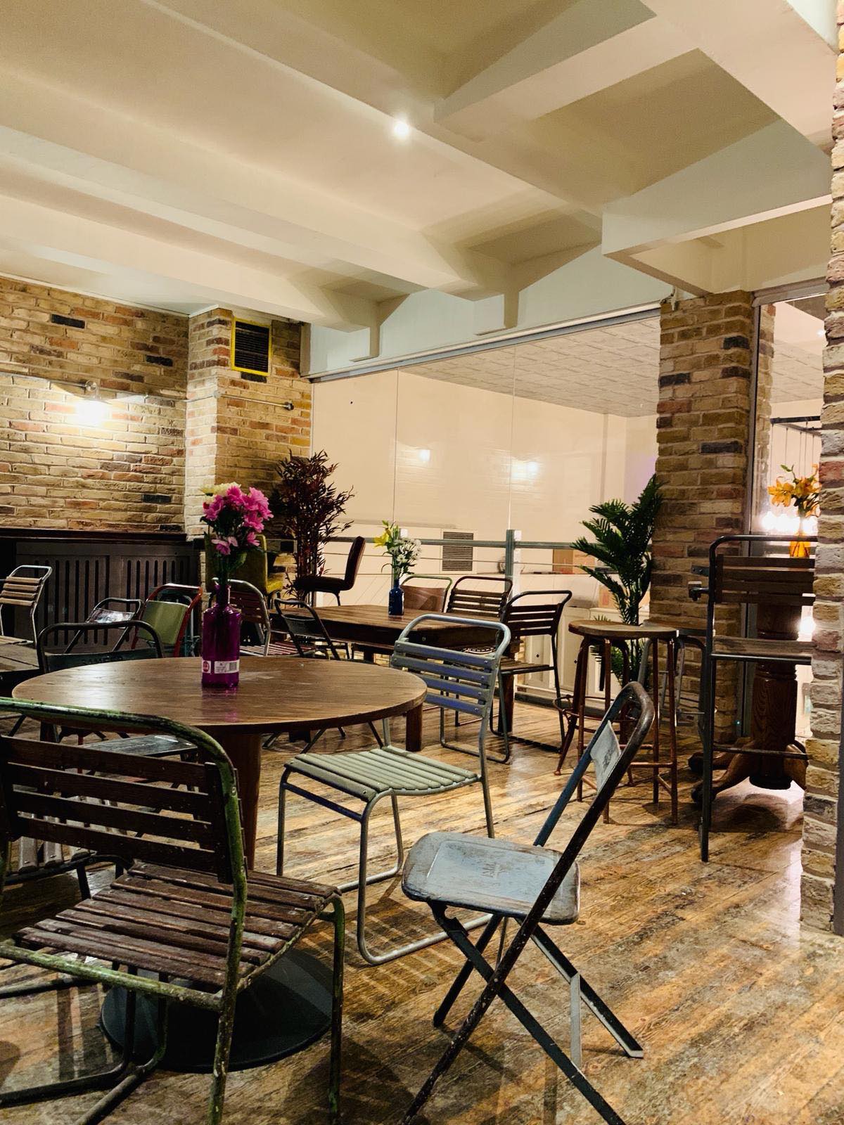 Versatile event space with wooden furniture, ideal for networking events and conferences.