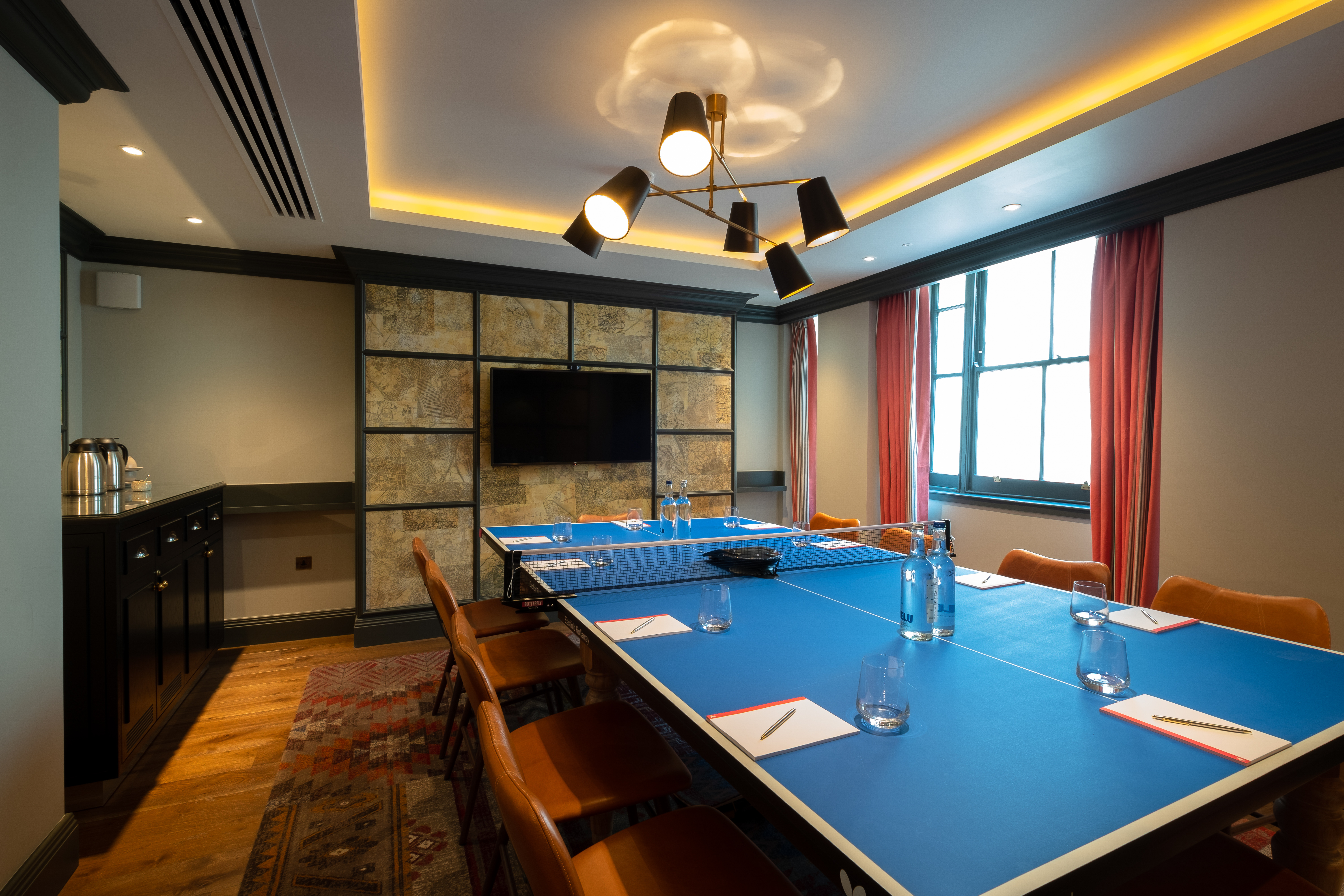 Pitching Rooms at Home Grown Club with blue conference table for professional meetings.