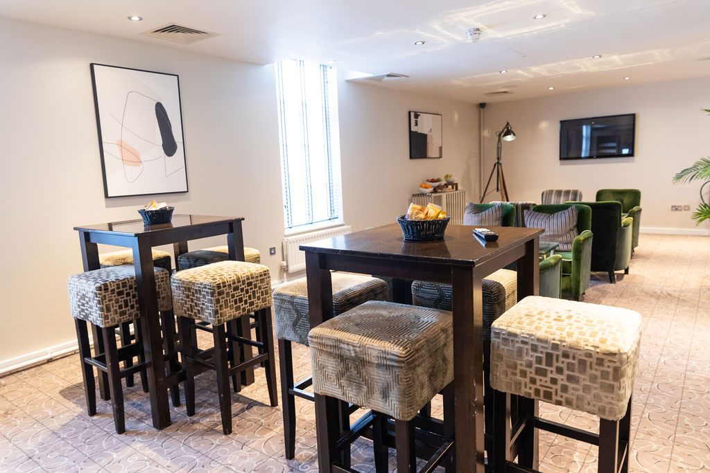 Modern meeting space at Mottram Hall with high-top tables for collaborative events.