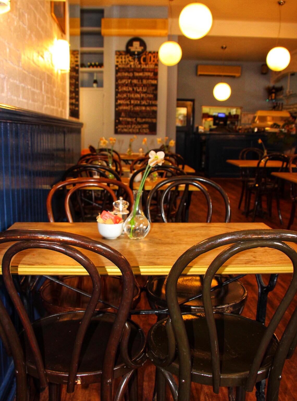 Cozy ground floor restaurant with wooden tables, perfect for intimate gatherings and meetings.