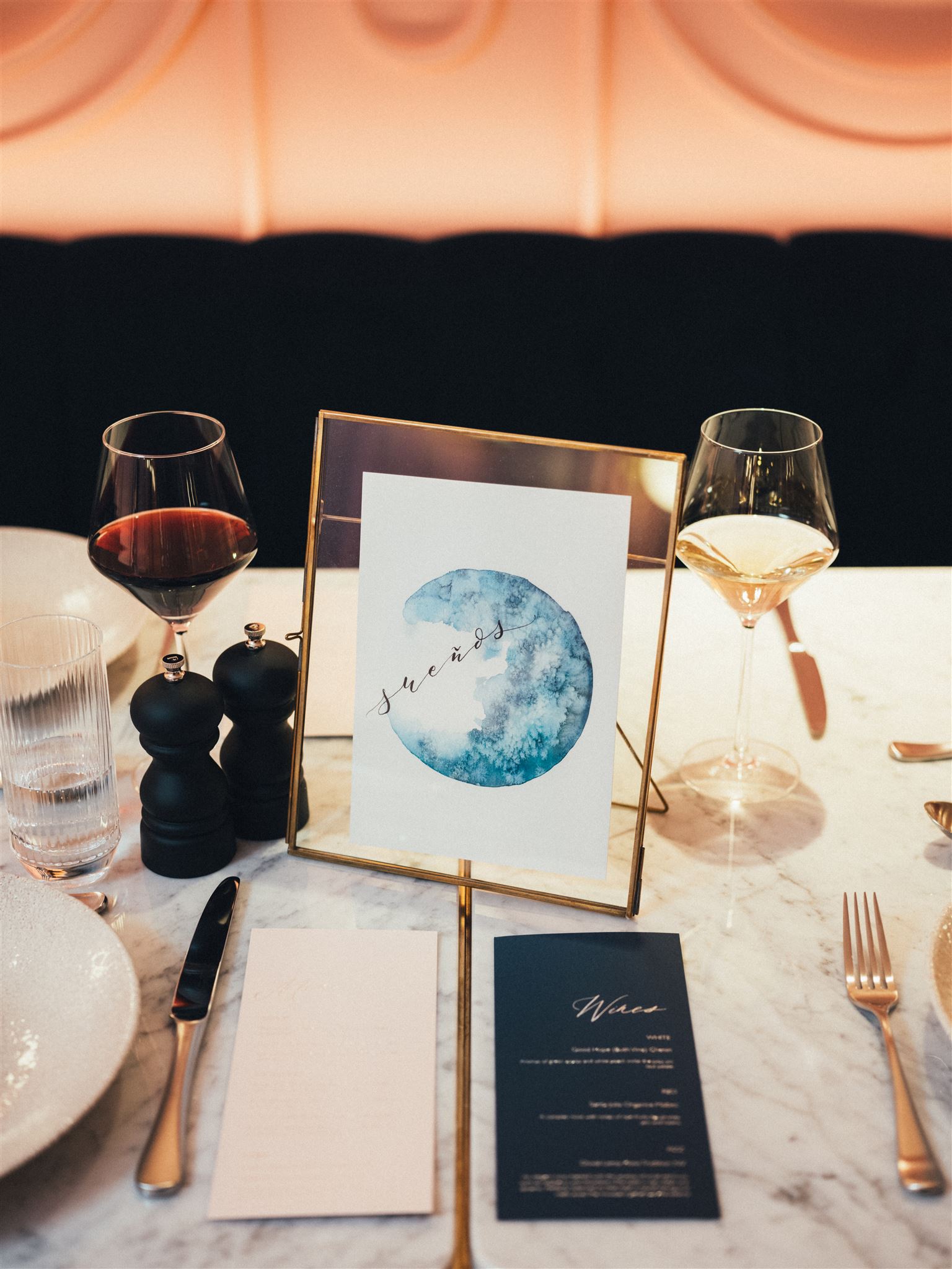 Elegant table setting with watercolor menu at a high-end restaurant for special events.