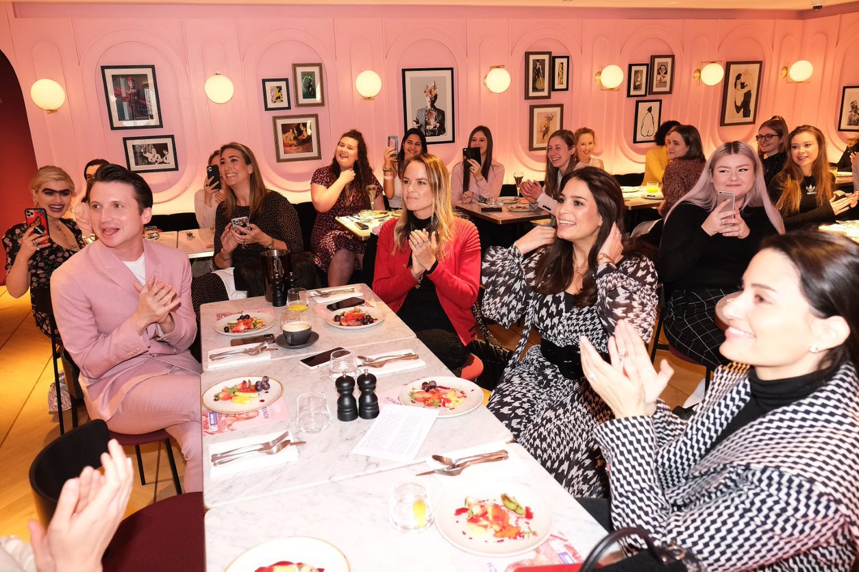 Vibrant restaurant event with pink decor, ideal for networking and gatherings.