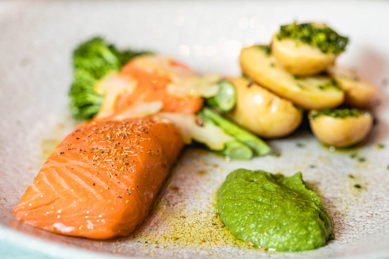 Plated salmon dish with broccoli and potatoes at Boulevard Restaurant and Bar event.