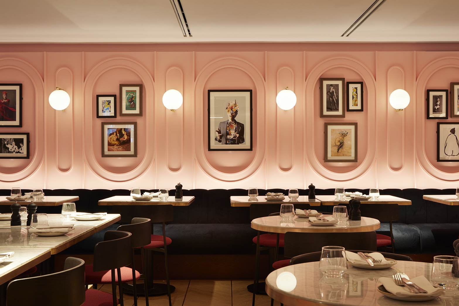 Stylish restaurant interior with pink walls, ideal for intimate gatherings or networking events.