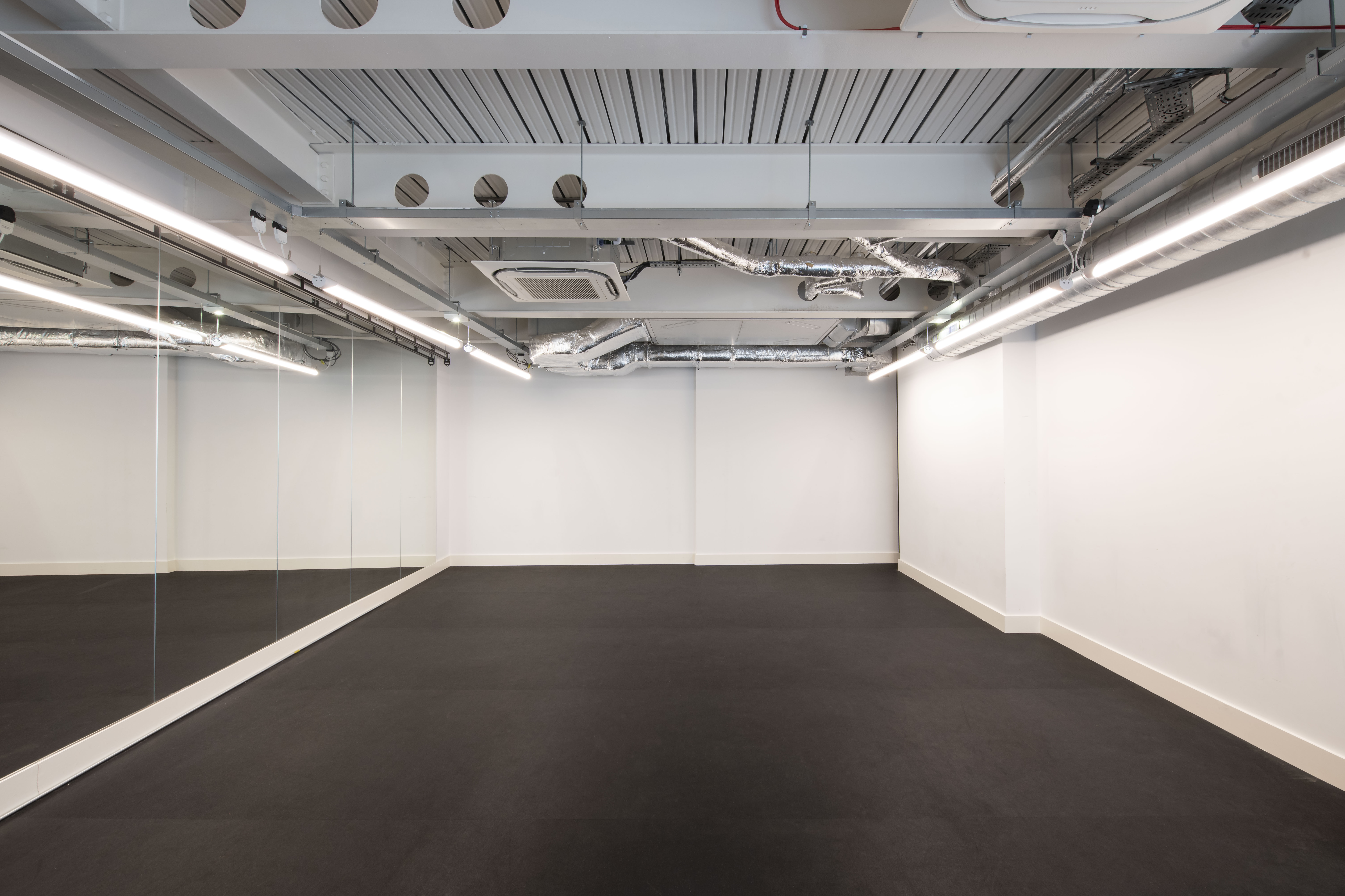 Versatile rehearsal room with mirrors for workshops and yoga sessions at The Boulevard.