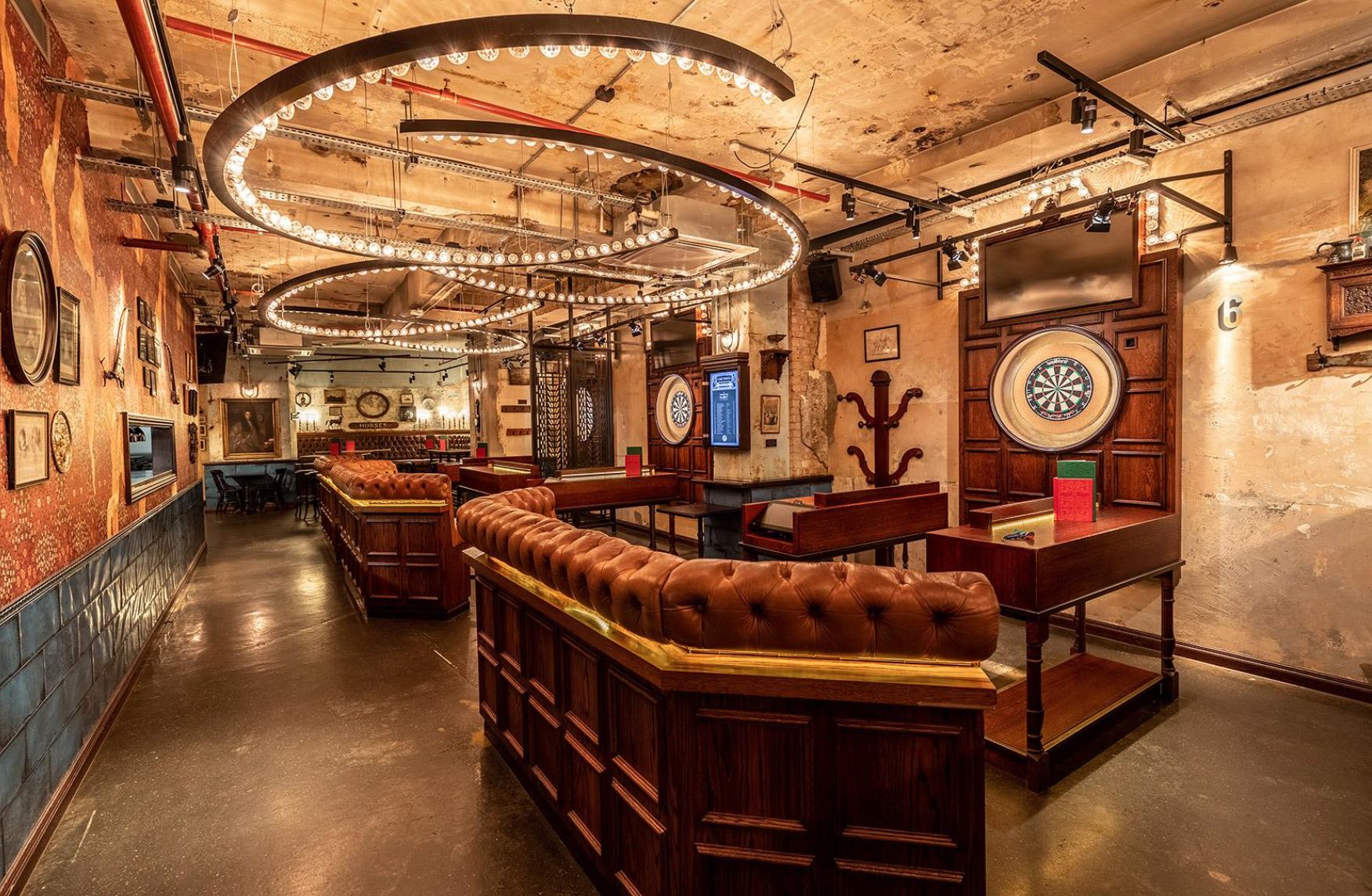 Stylish event space with vintage decor and dartboards for networking and team-building.