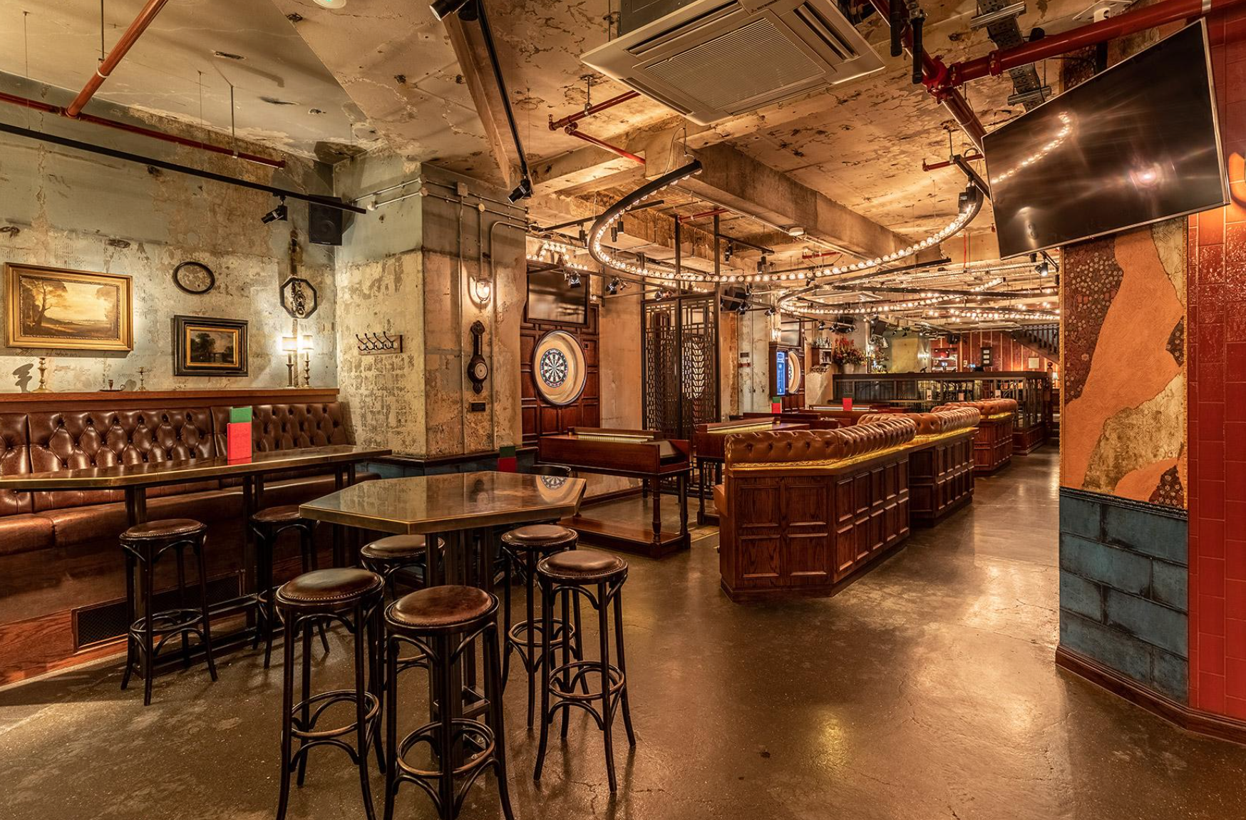 Versatile event space at Flight Club Shoreditch with exposed brick, ideal for gatherings.