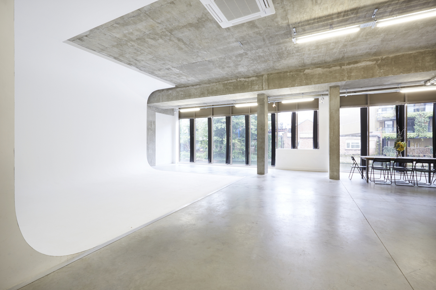 Versatile minimalist event space with white backdrop and natural light at LOCK Studios.