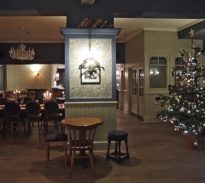 Cozy event space with Christmas tree, ideal for holiday parties at William Morris Bar.