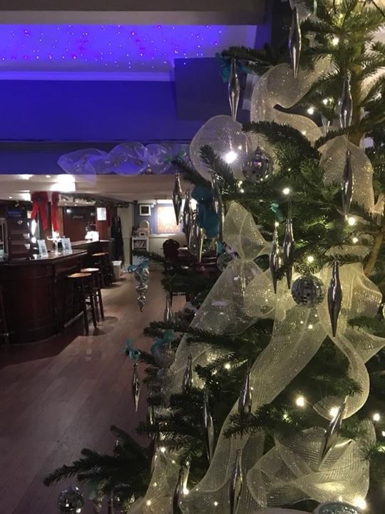 Festive Christmas tree in The William Morris Bar, ideal for holiday events and parties.