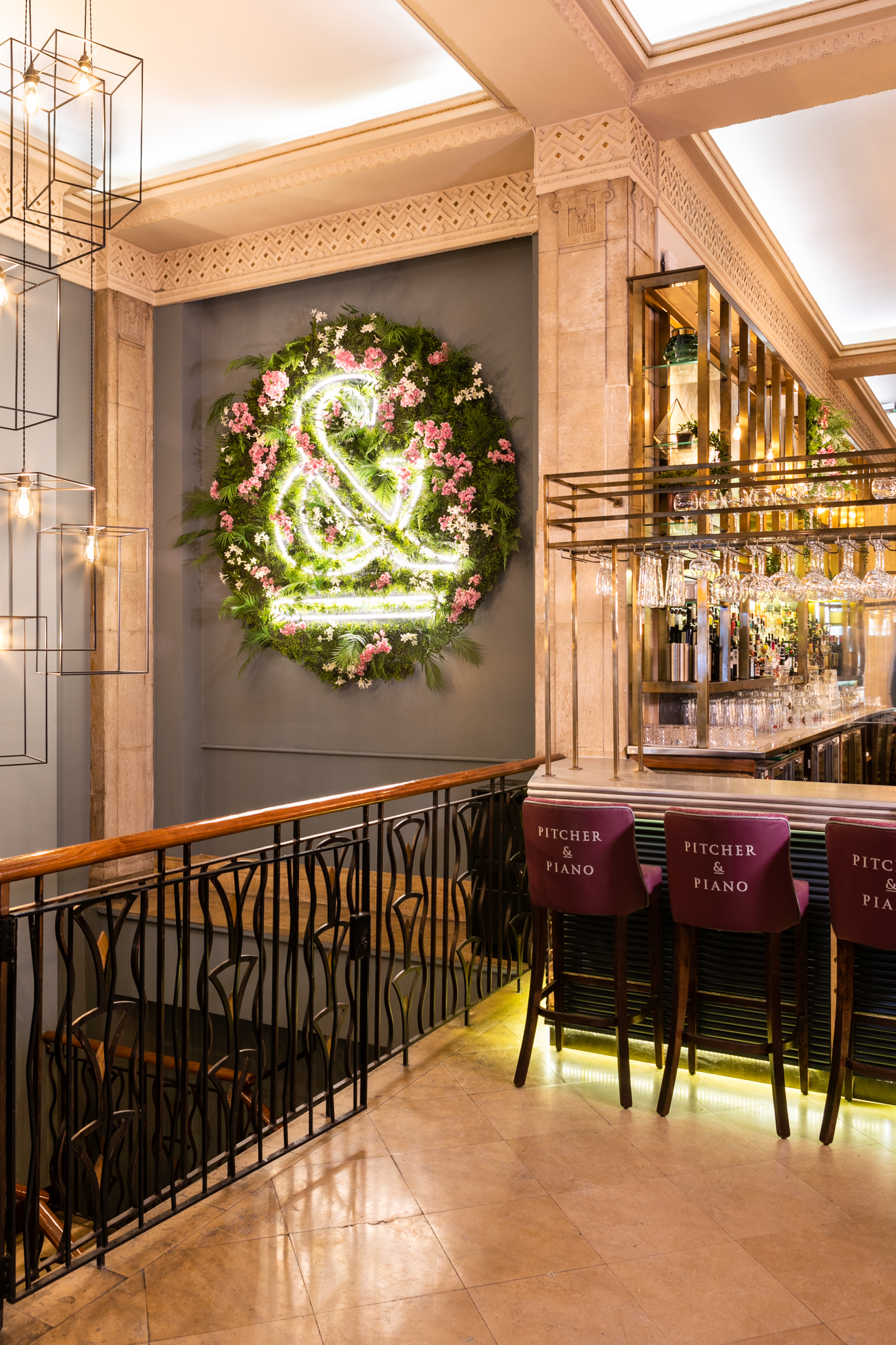 Stylish venue with floral decor and neon lights, perfect for networking events or gatherings.