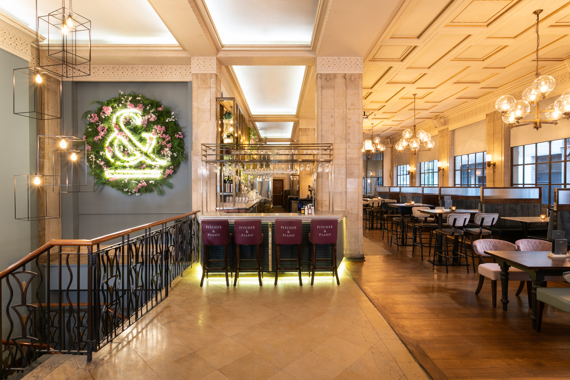 Stylish venue at Pitcher & Piano Cornhill with floral neon sign for events and gatherings.