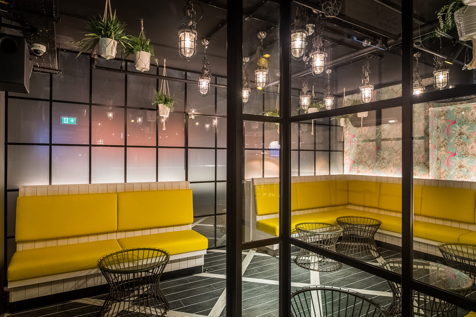 Modern Sun Room with yellow seating, ideal for creative meetings and networking events.