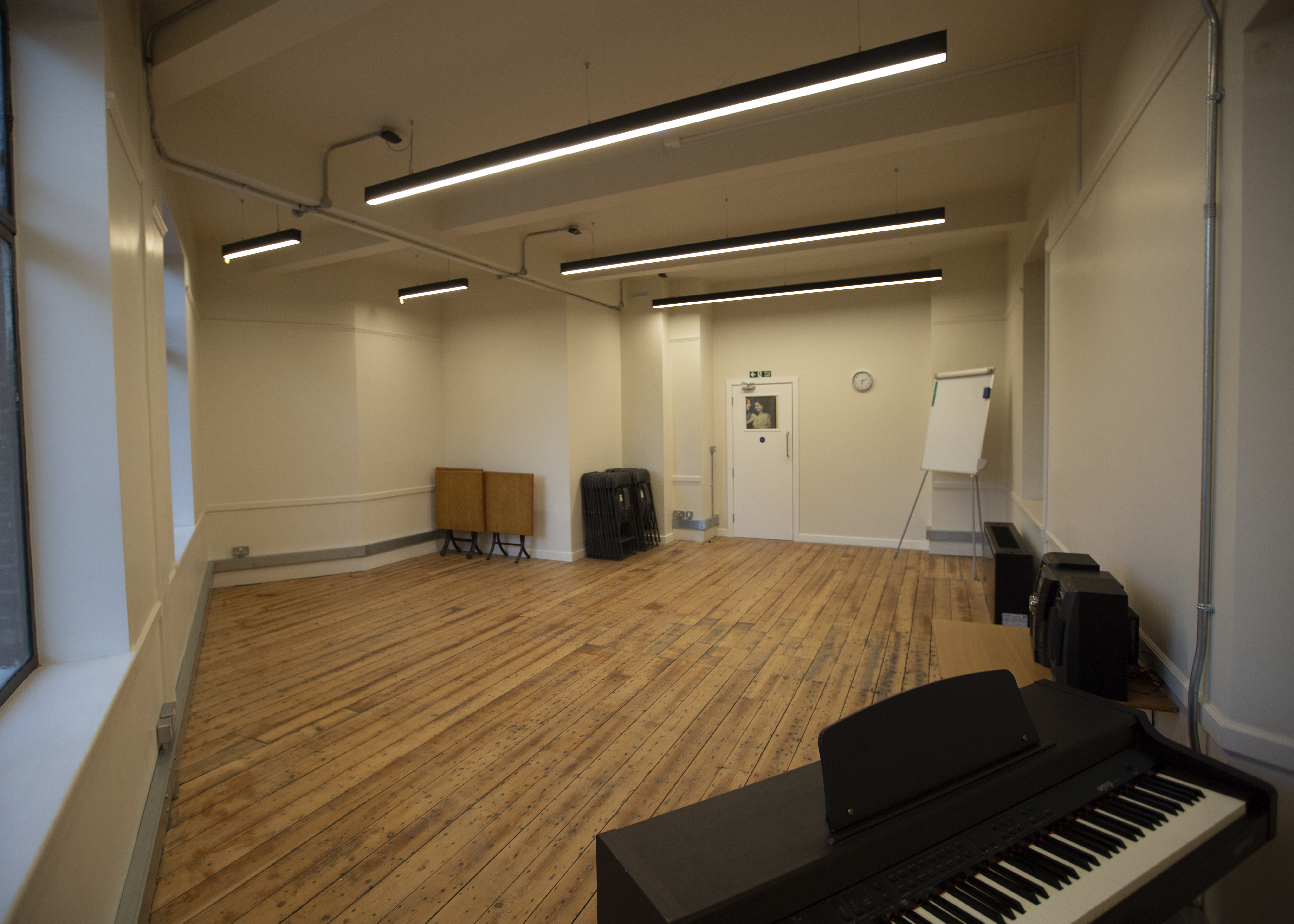 Versatile meeting space with wooden floor for workshops at International College of Musical Theatre.