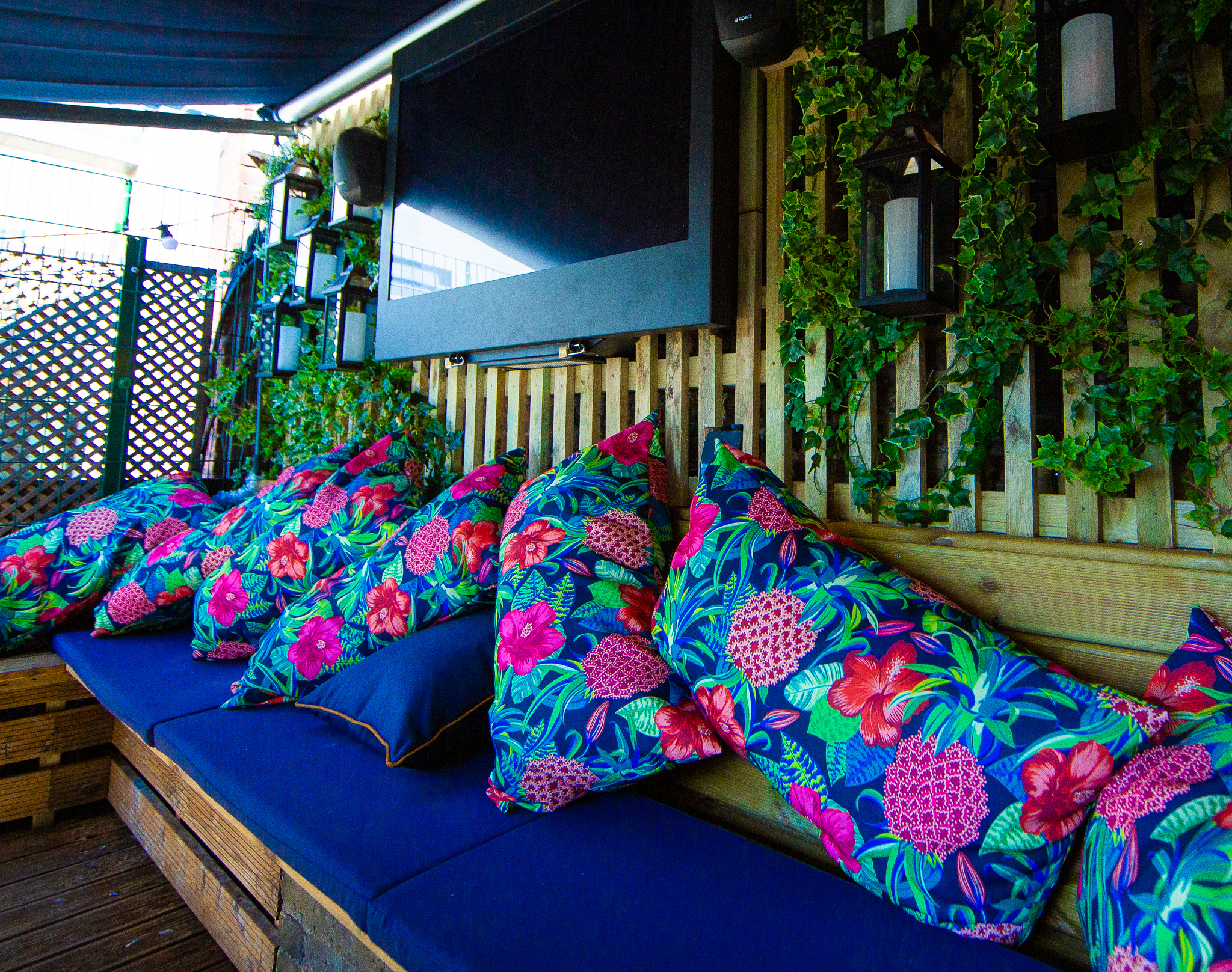 Vibrant lounge with floral pillows at Bow Street Tavern for networking events.