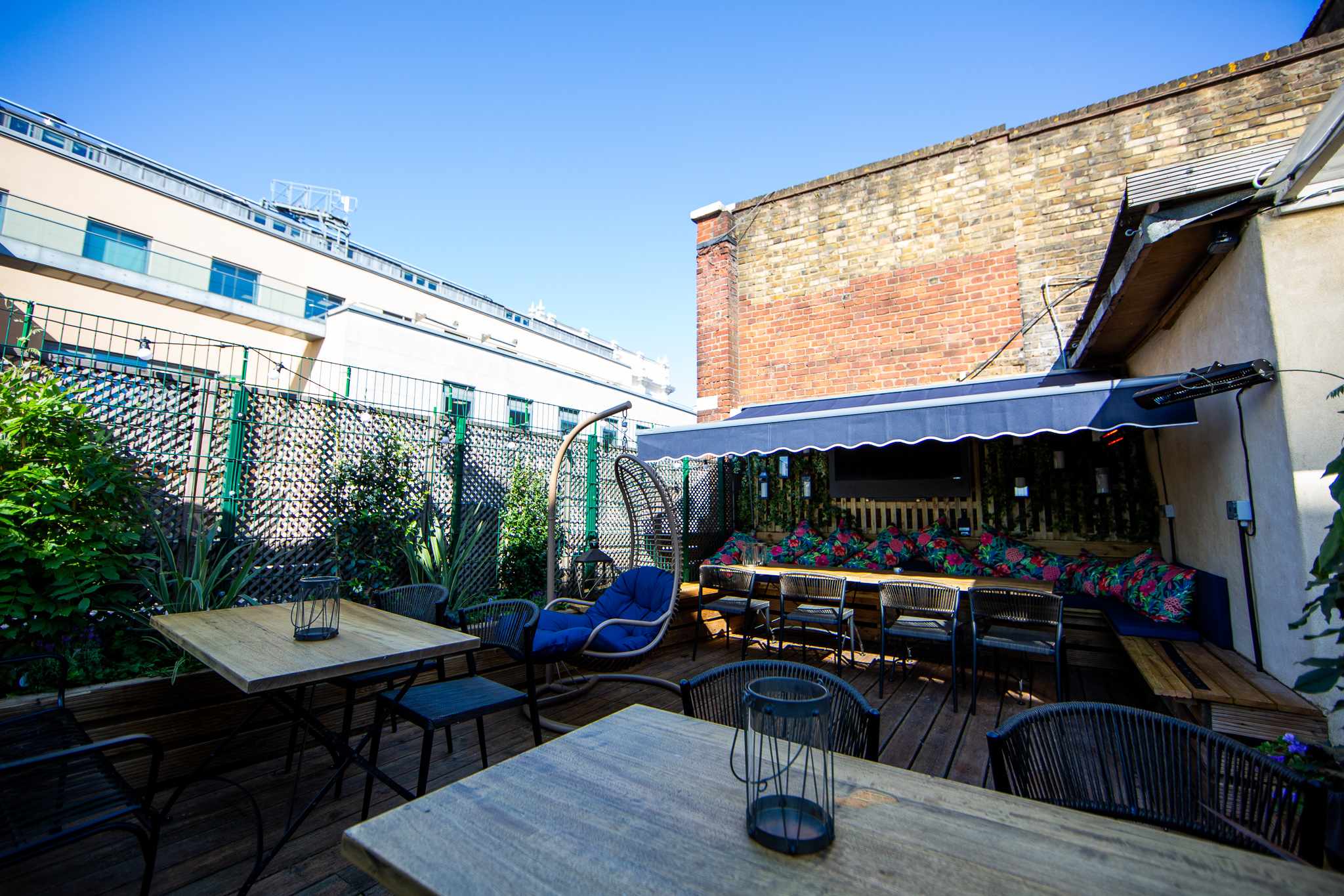Charming outdoor event space at Bow Street Tavern with greenery and comfortable seating.
