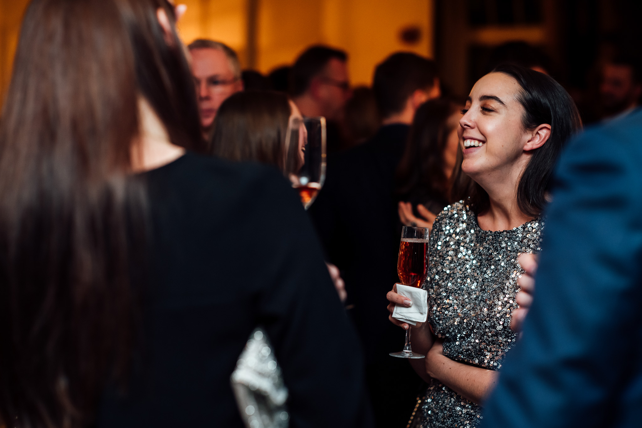 Attendees networking at a festive cocktail reception in a town house venue for corporate events.