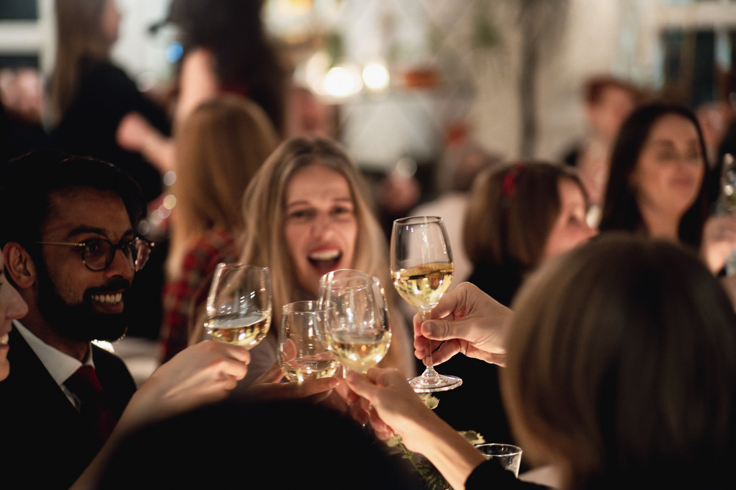 Gala networking reception in a festive townhouse with guests toasting at a successful event.