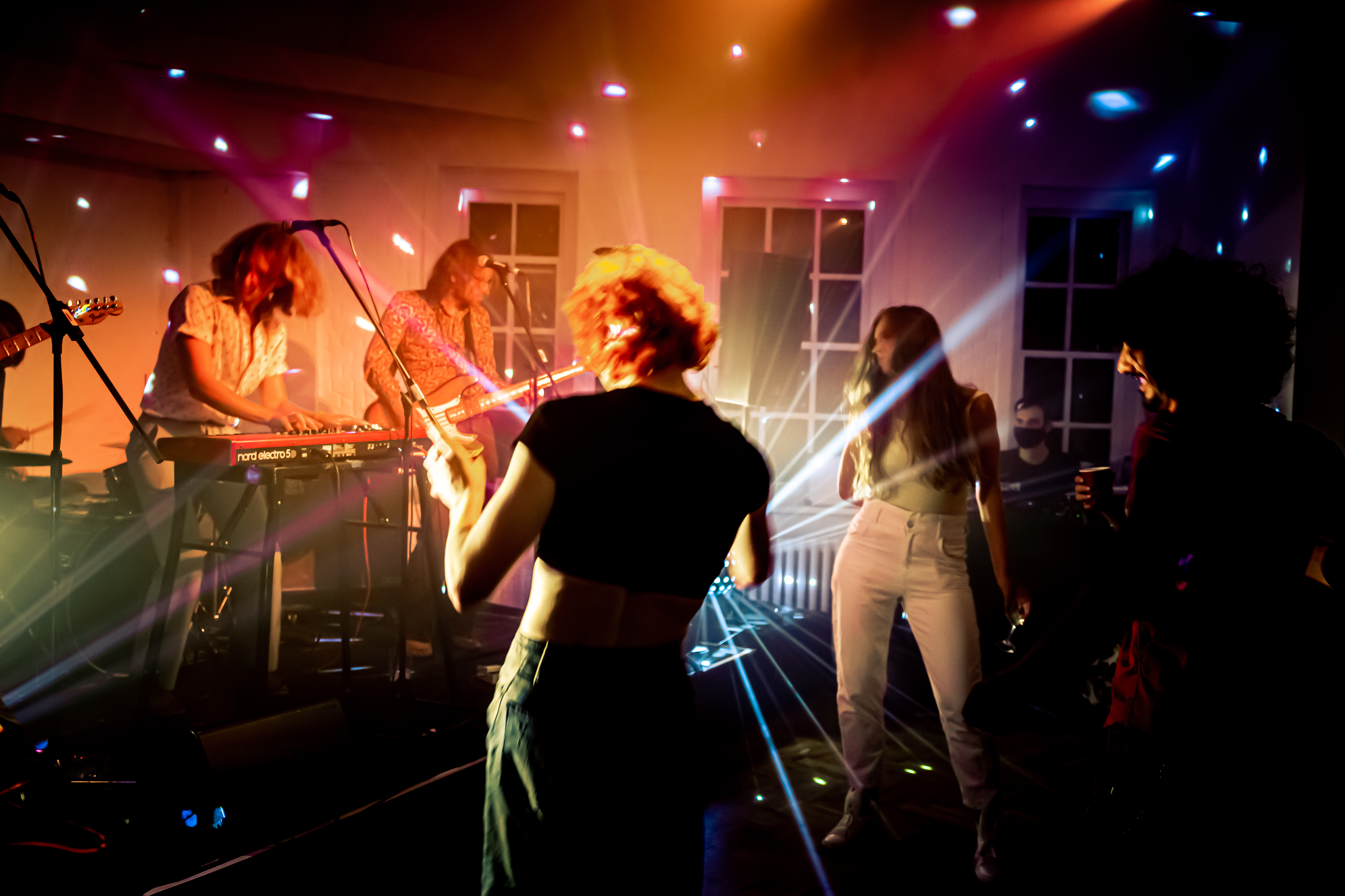 Festive townhouse venue with dynamic lighting for high-energy corporate party reception.