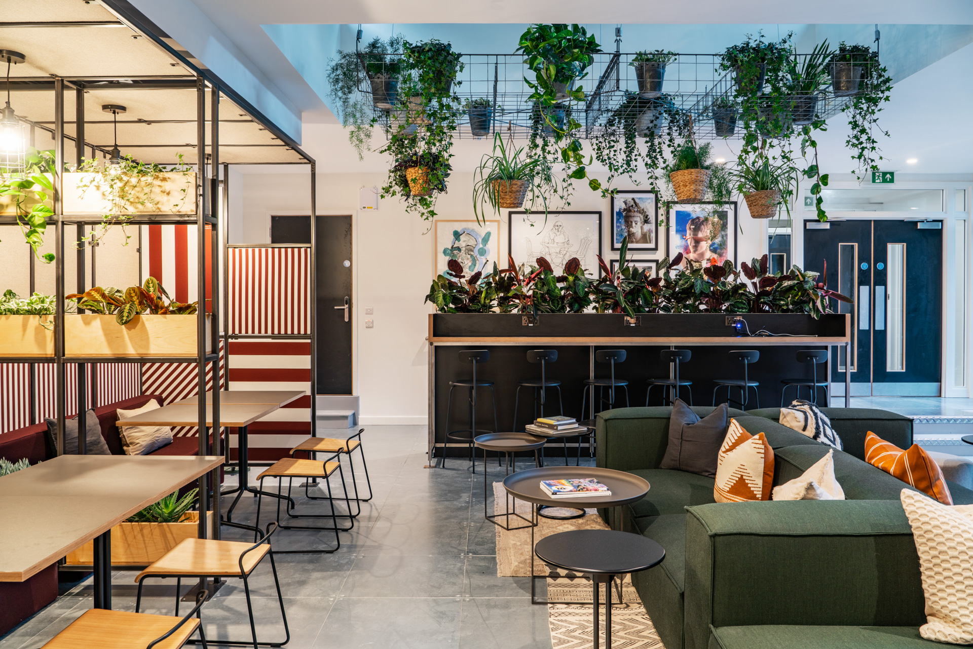 Modern event space in People's Mission Hall with casual seating and greenery for networking.