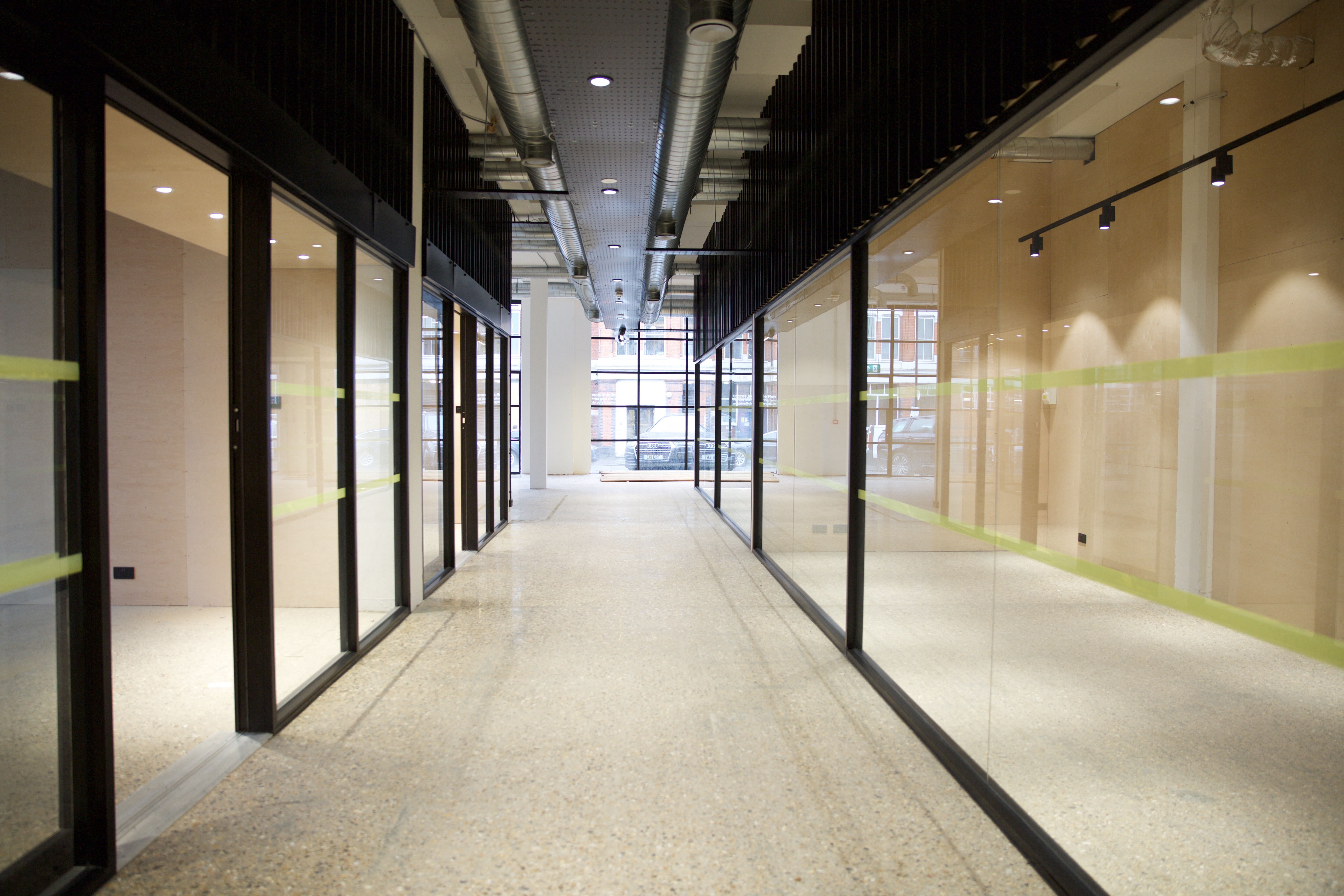 Modern corridor with glass walls in The Factory Dalston, ideal for networking events.
