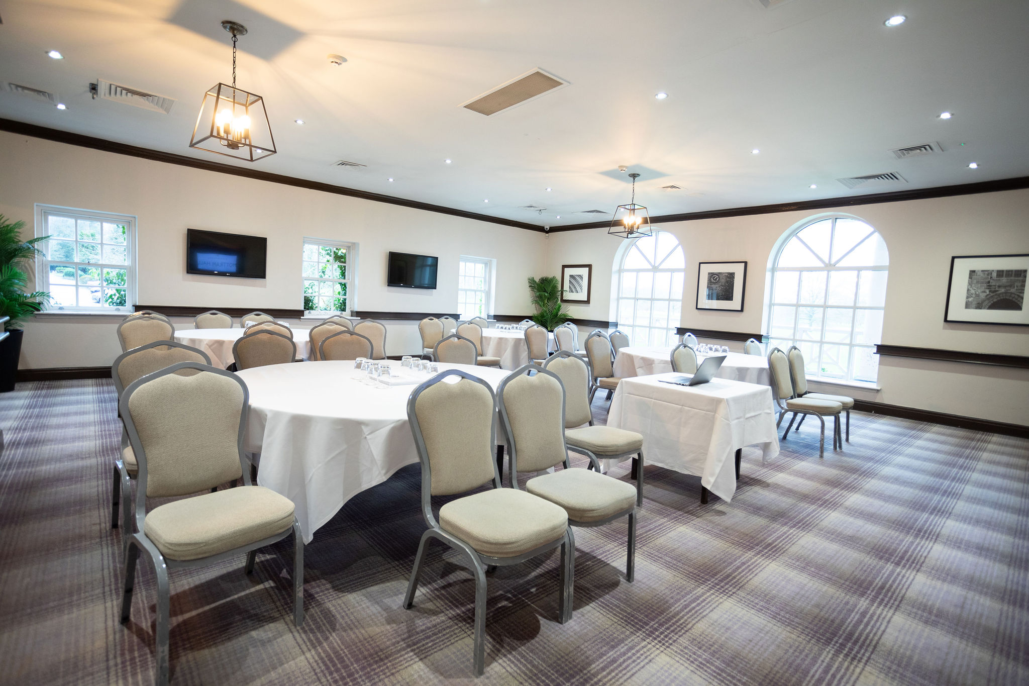 Thomas Suite at Mottram Hall: bright meeting room with round tables for events and workshops.