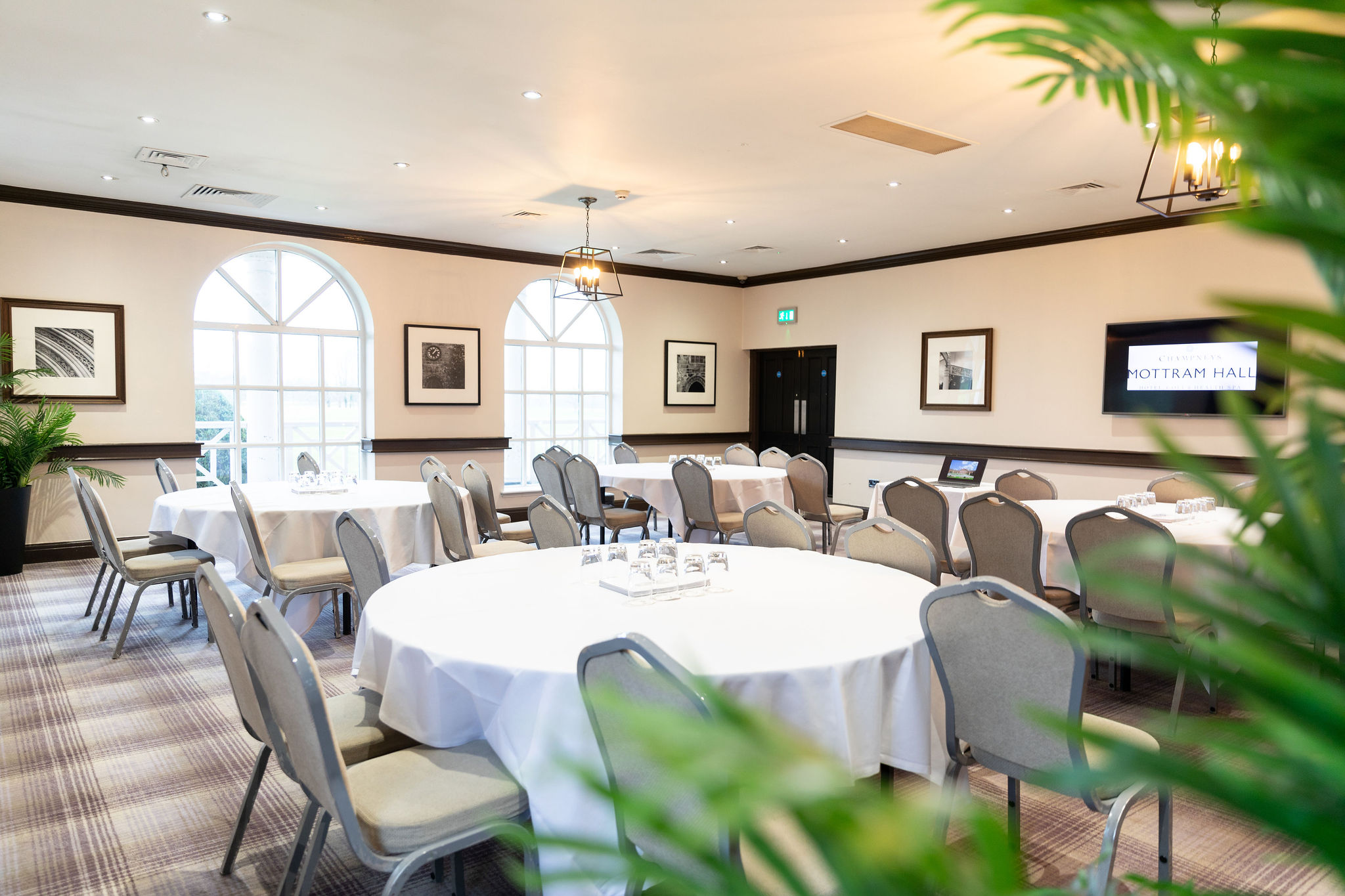 Thomas Suite at Mottram Hall, elegant meeting room with round tables for corporate events.