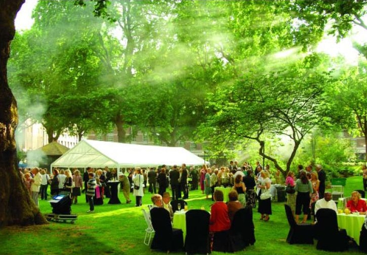 Portman Square Garden event with elegant attendees under a large tent, ideal for networking.