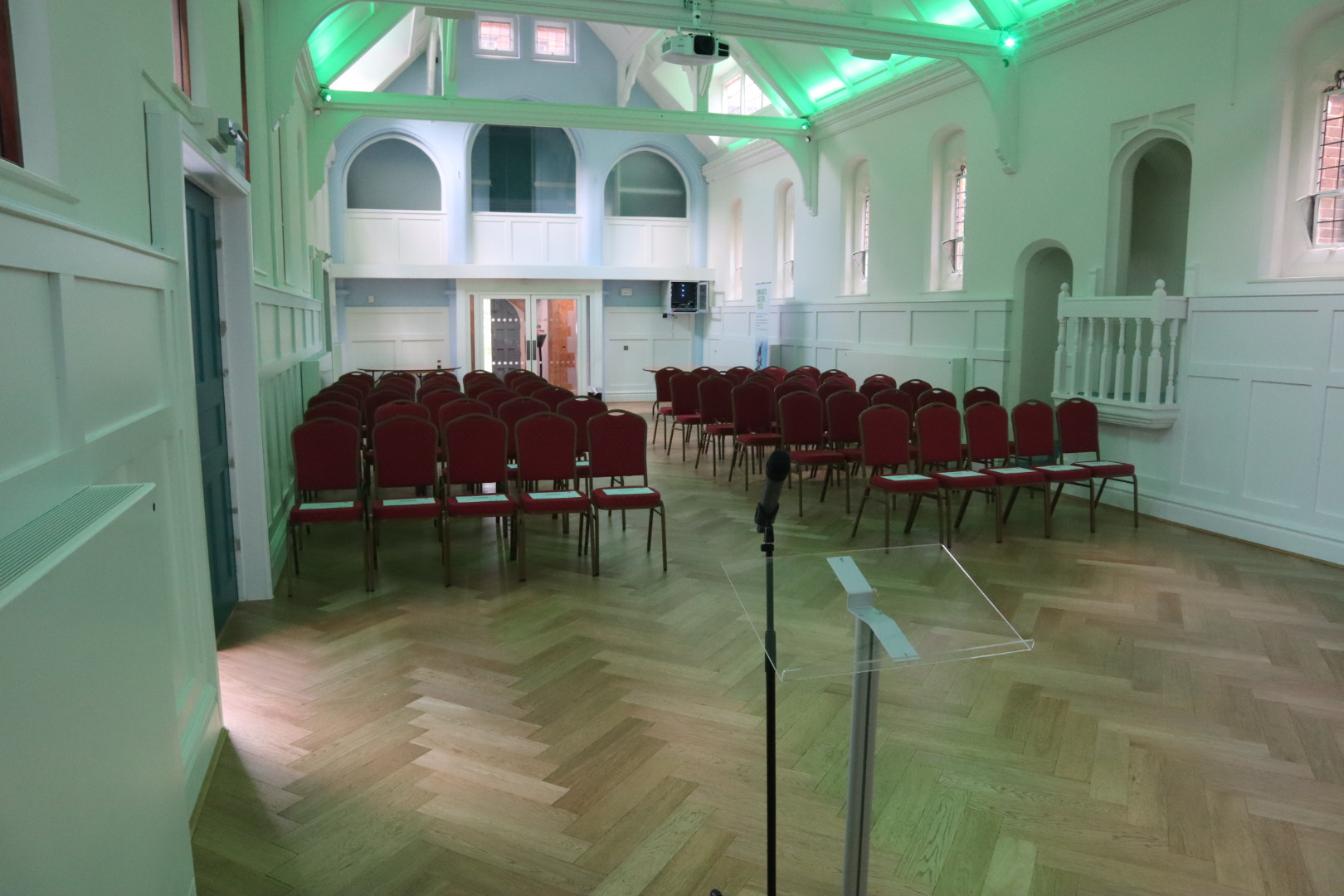 Byculla Suite in Ashburton Hall: elegant event space with red chairs for presentations.
