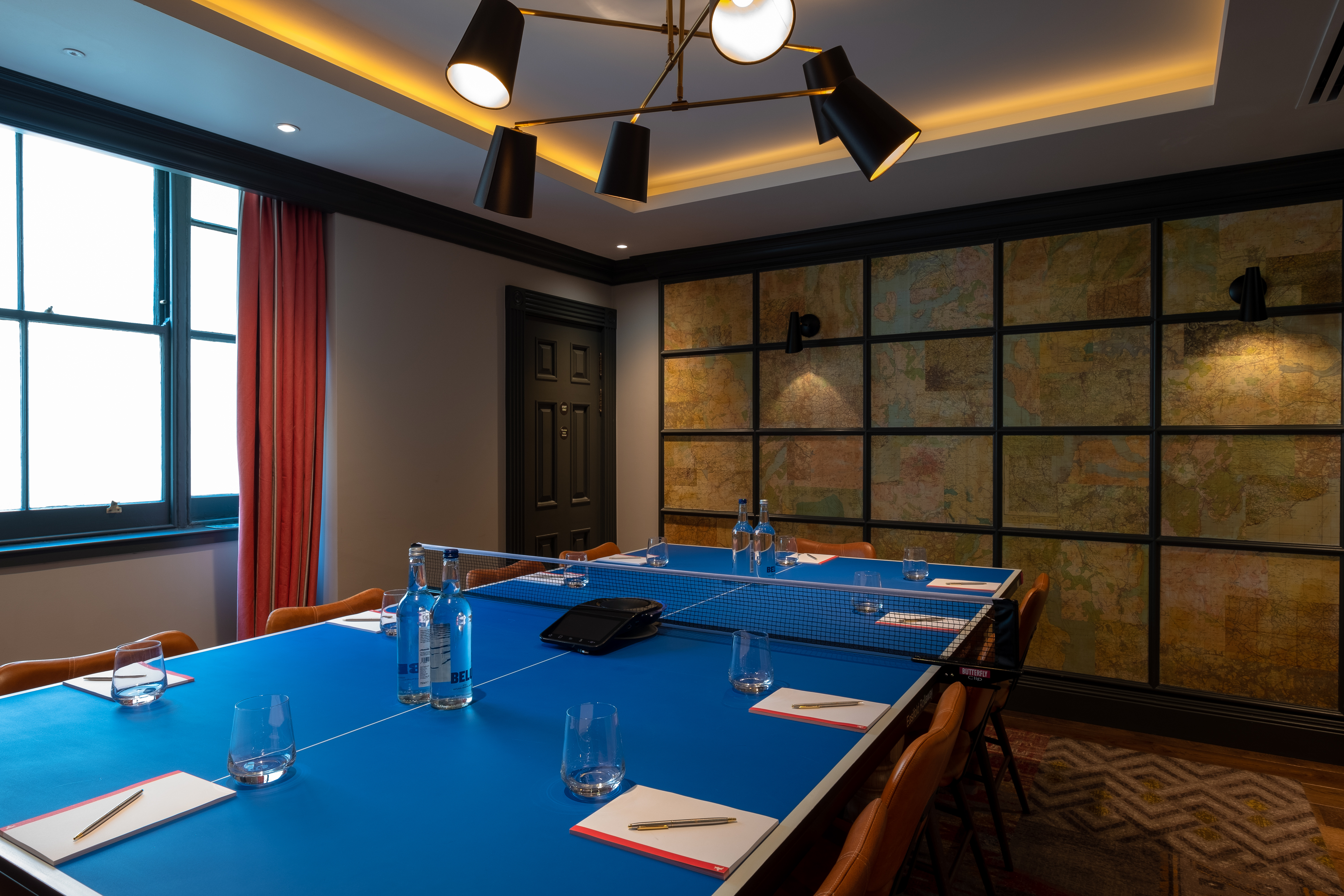Pitching Rooms at Home Grown Club: modern meeting space with blue table for collaboration.