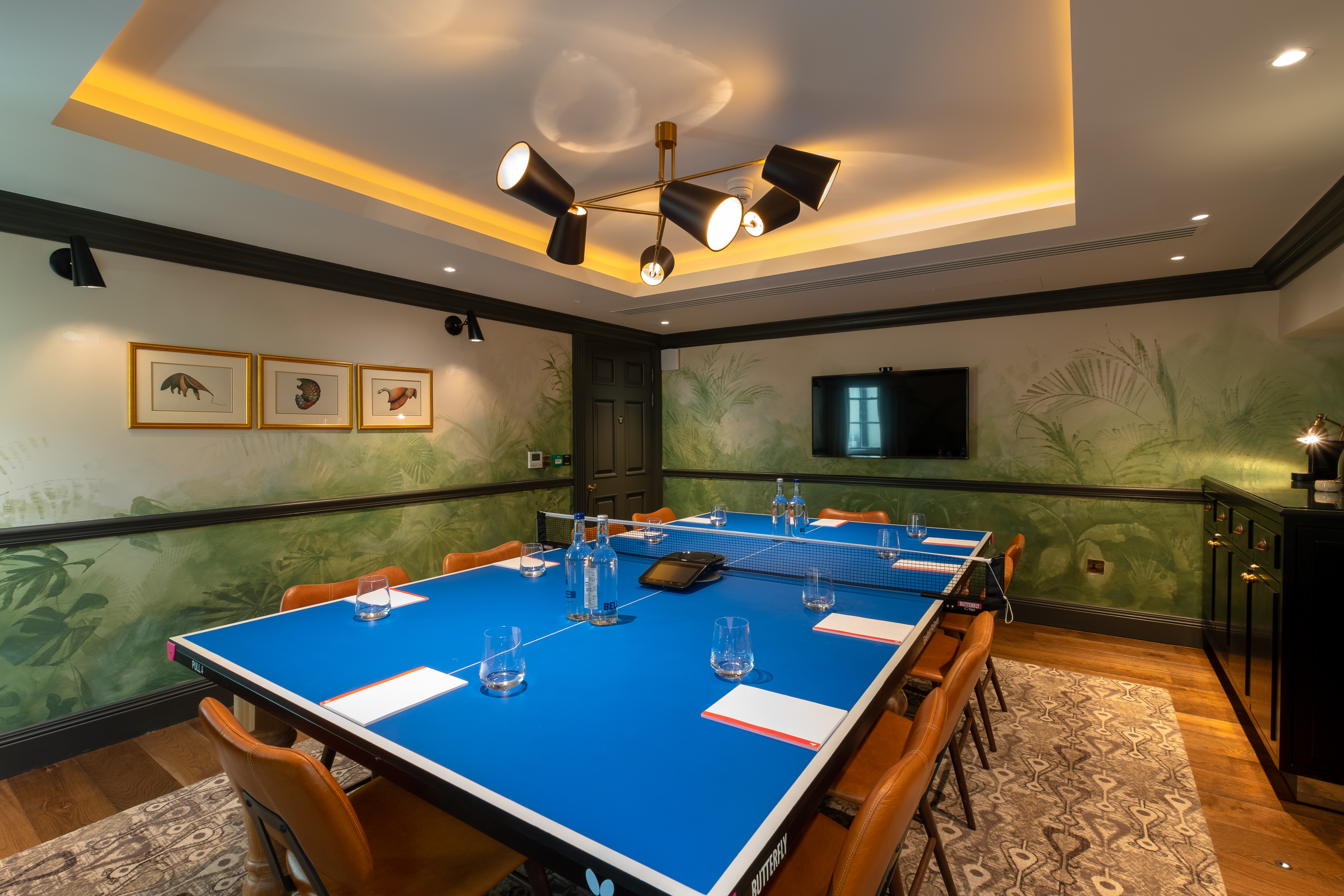 Pitching Rooms at Home Grown Club with blue table, perfect for meetings and brainstorming.
