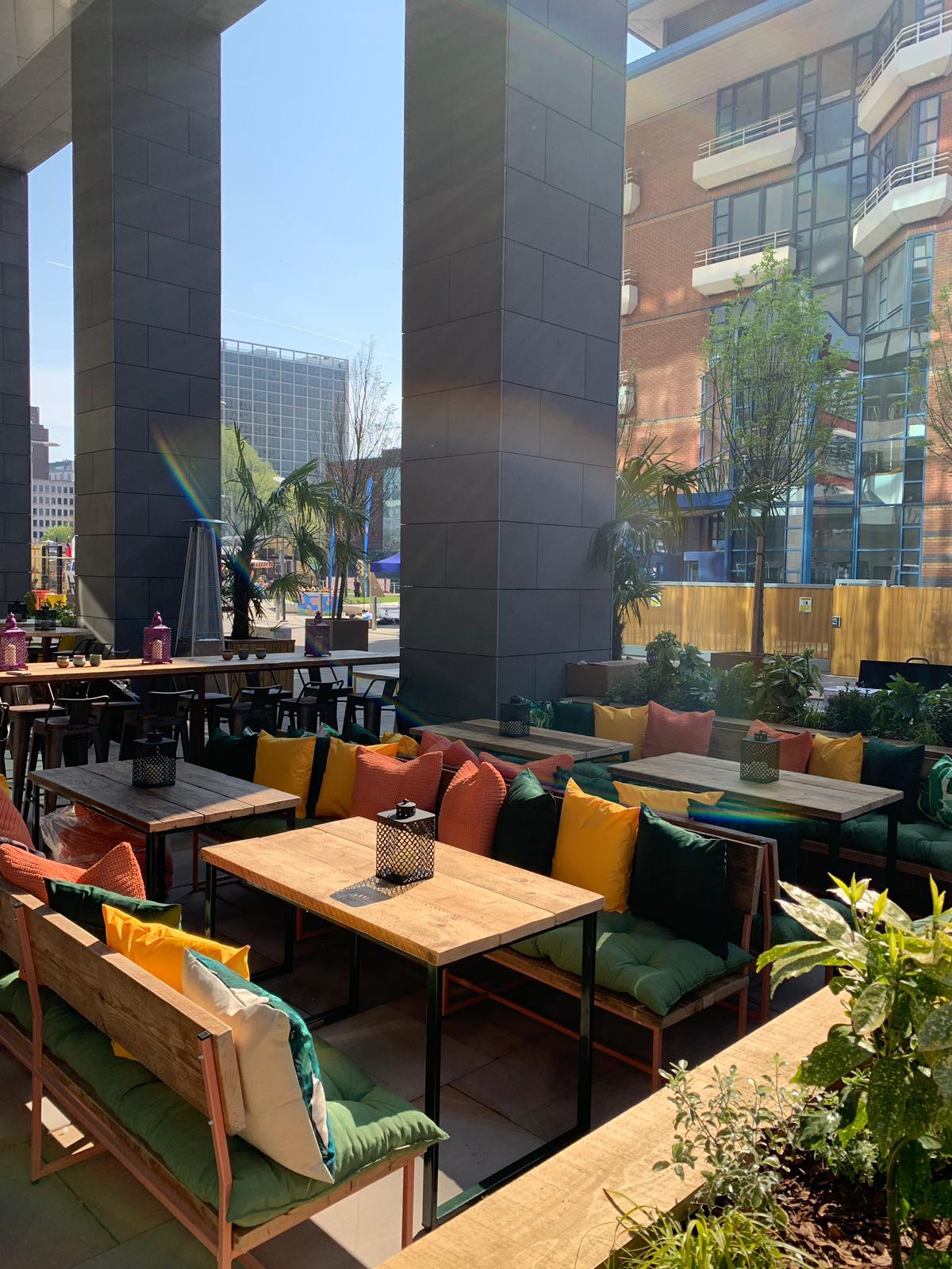 Vibrant outdoor event space at FoodWell with stylish seating for networking gatherings.