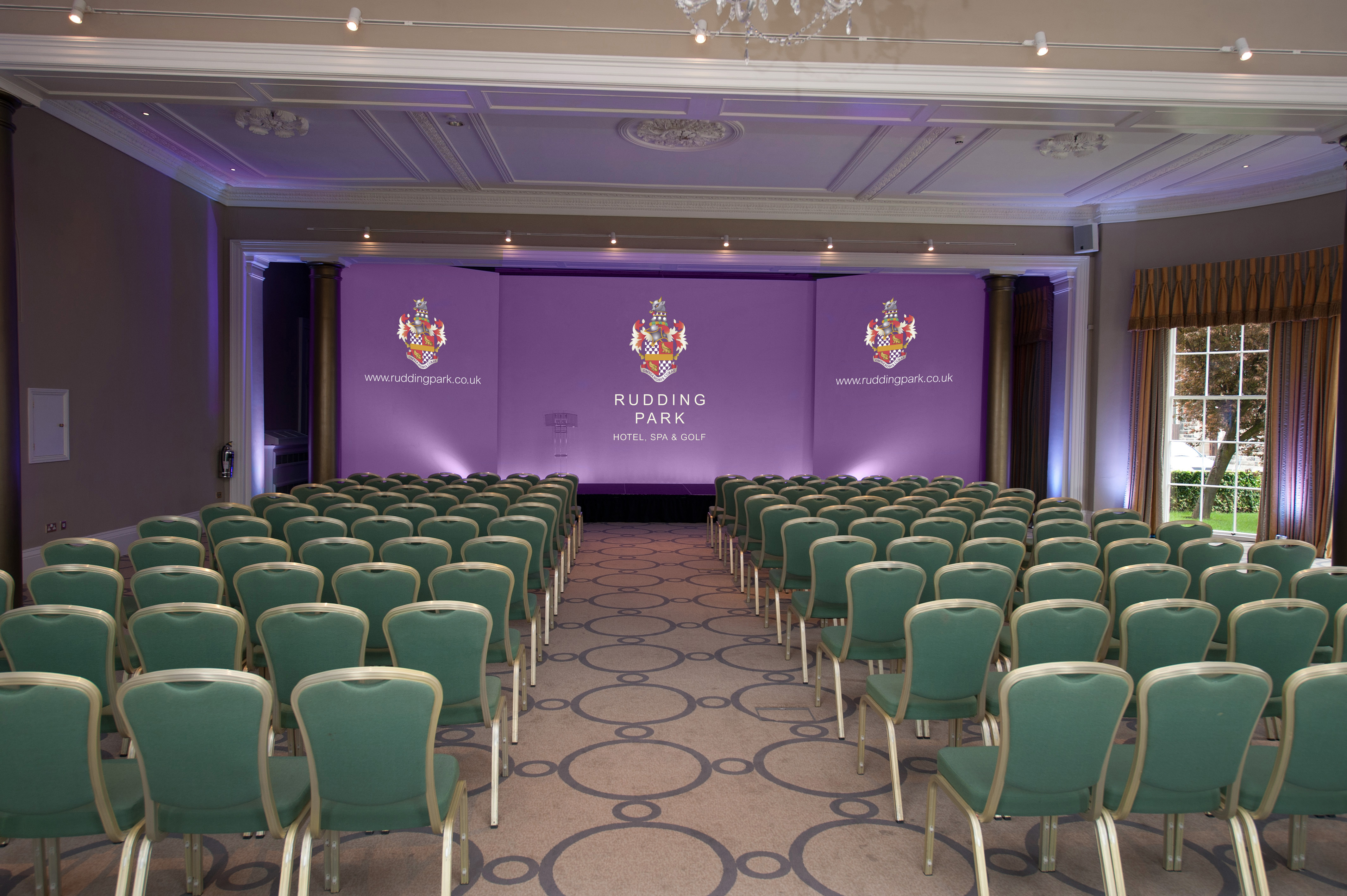 Conference room at Rudding Park with green chairs, ideal for corporate events and seminars.
