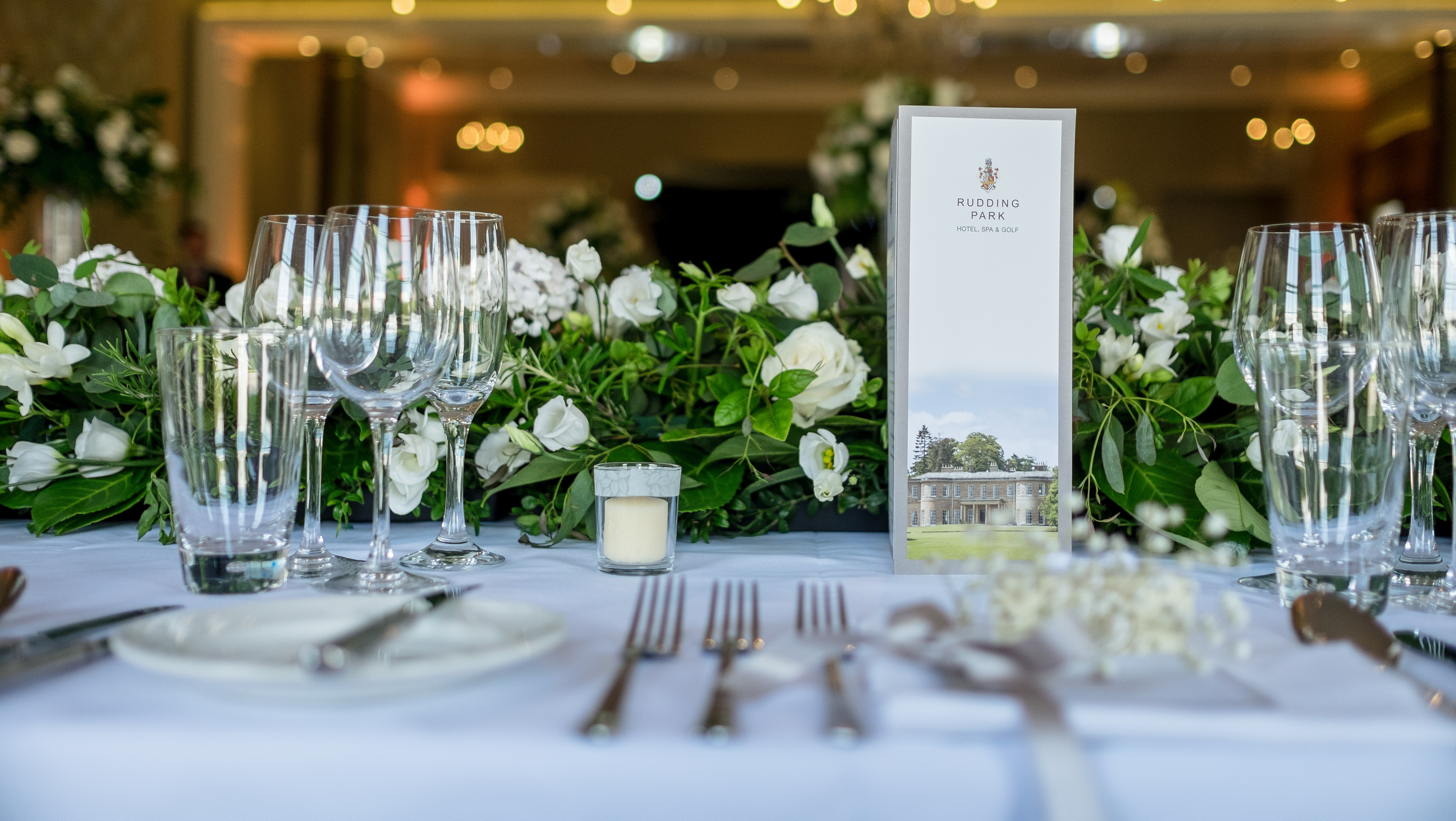 Elegant dining table setup with floral centerpieces for events at Rudding Park.