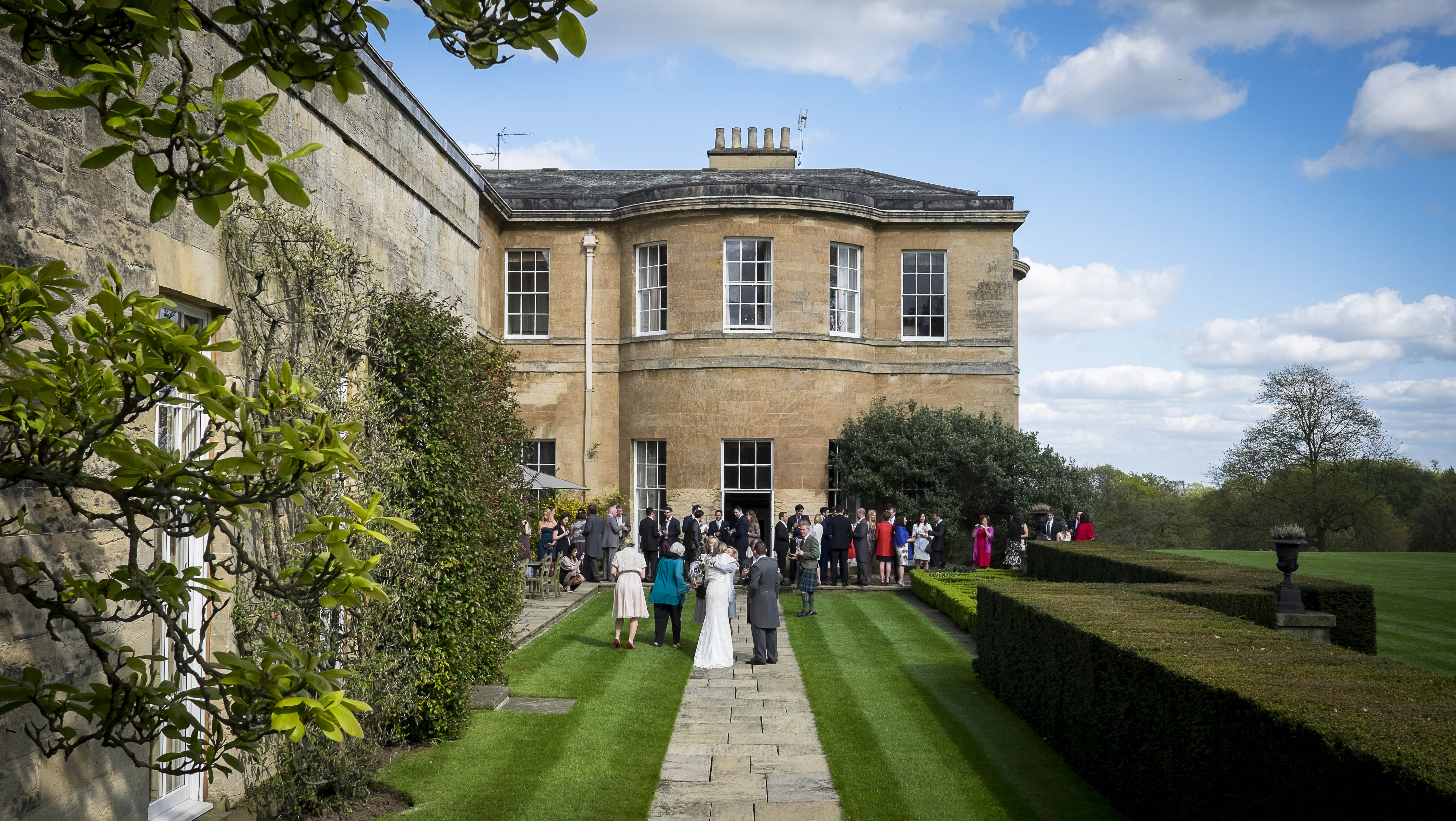 Outdoor wedding at Rudding Park Library with lush greenery and historic charm.