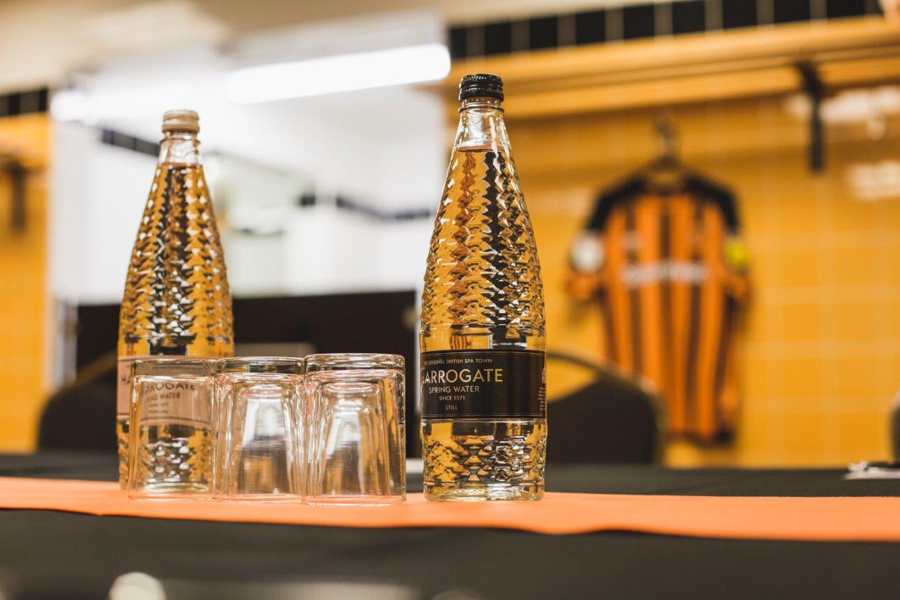 MKM Stadium meeting setup with bottled water, ideal for sports events and conferences.