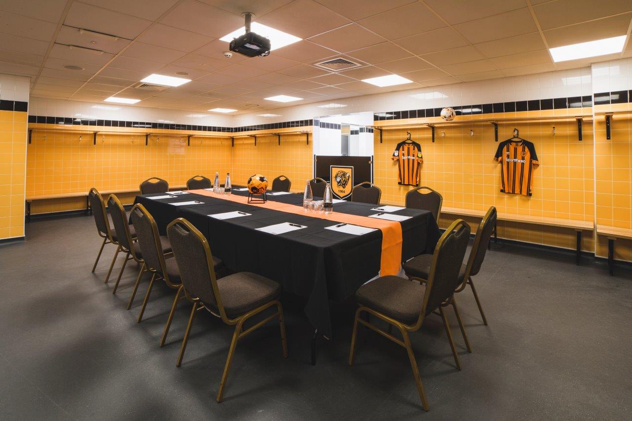 MKM Stadium locker room meeting space with vibrant decor for team-building events.