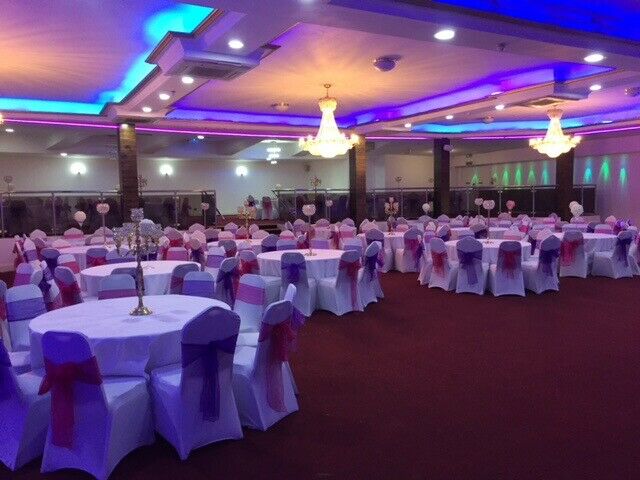 Elegant Praba Banqueting Suite with round tables, ideal for weddings and celebrations.