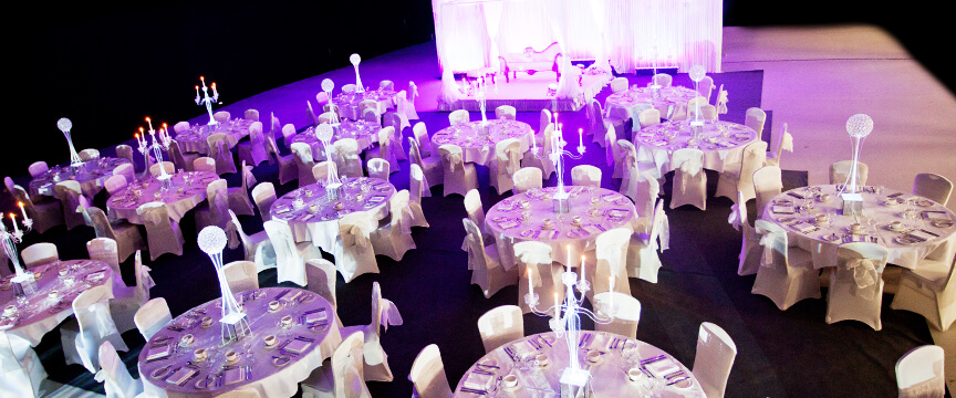 Upscale gala reception at Edgbaston Stadium with elegant table settings and dramatic uplighting.