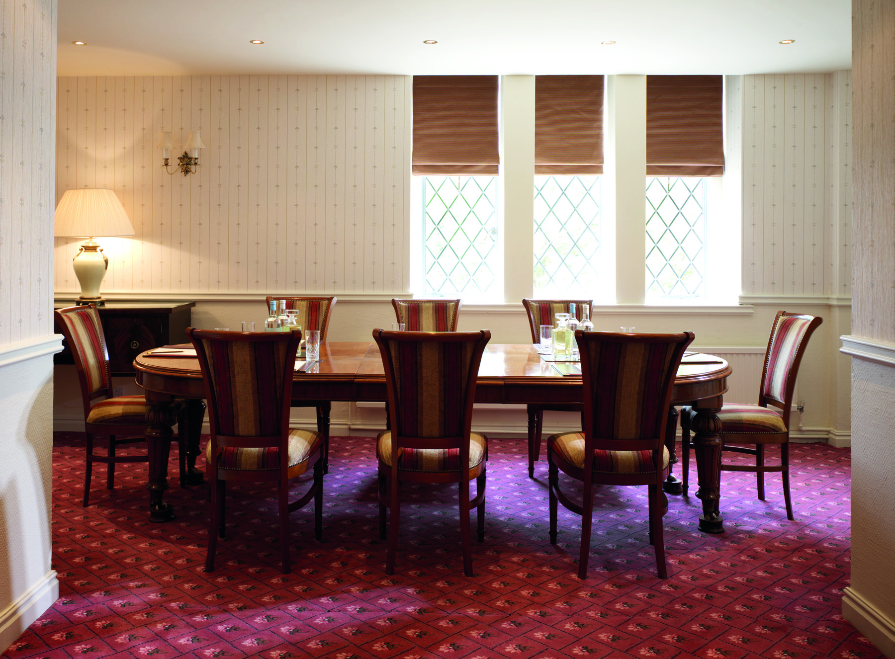 Anita Lunn in a sophisticated meeting room at Ashdown Park Hotel for strategic planning.