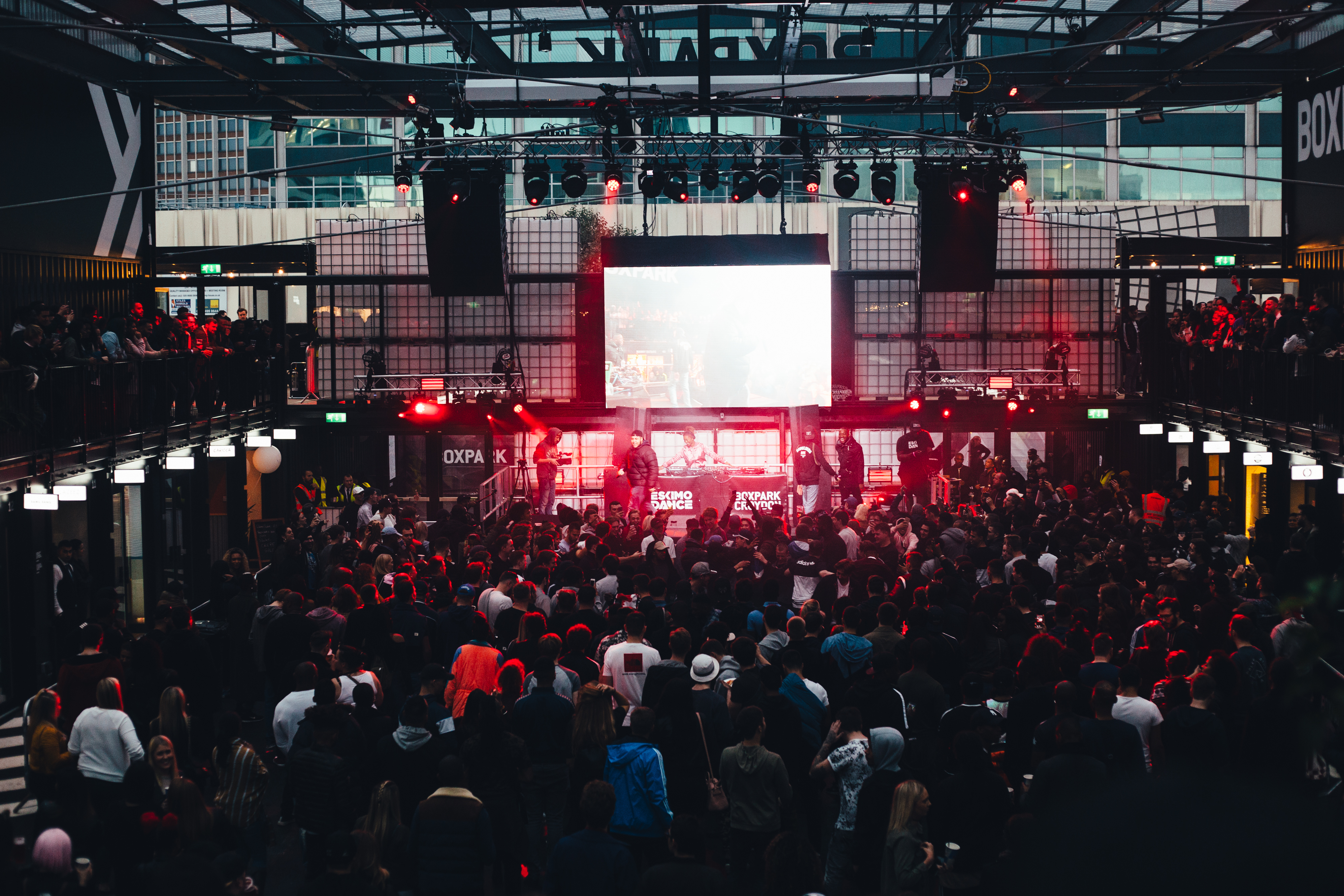 Vibrant venue takeover event at Boxpark Croydon with dynamic lighting and large crowd.