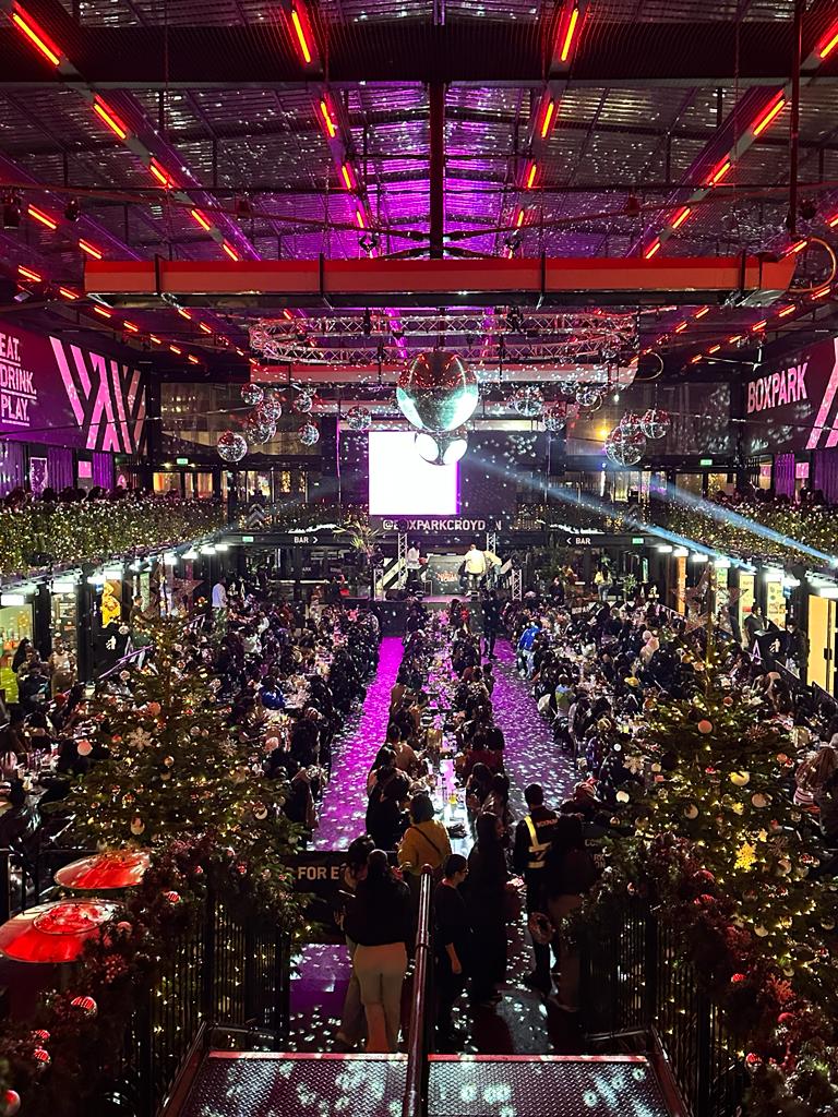 Exclusive Hire venue takeover at Boxpark Croydon, vibrant event space with colorful lights.